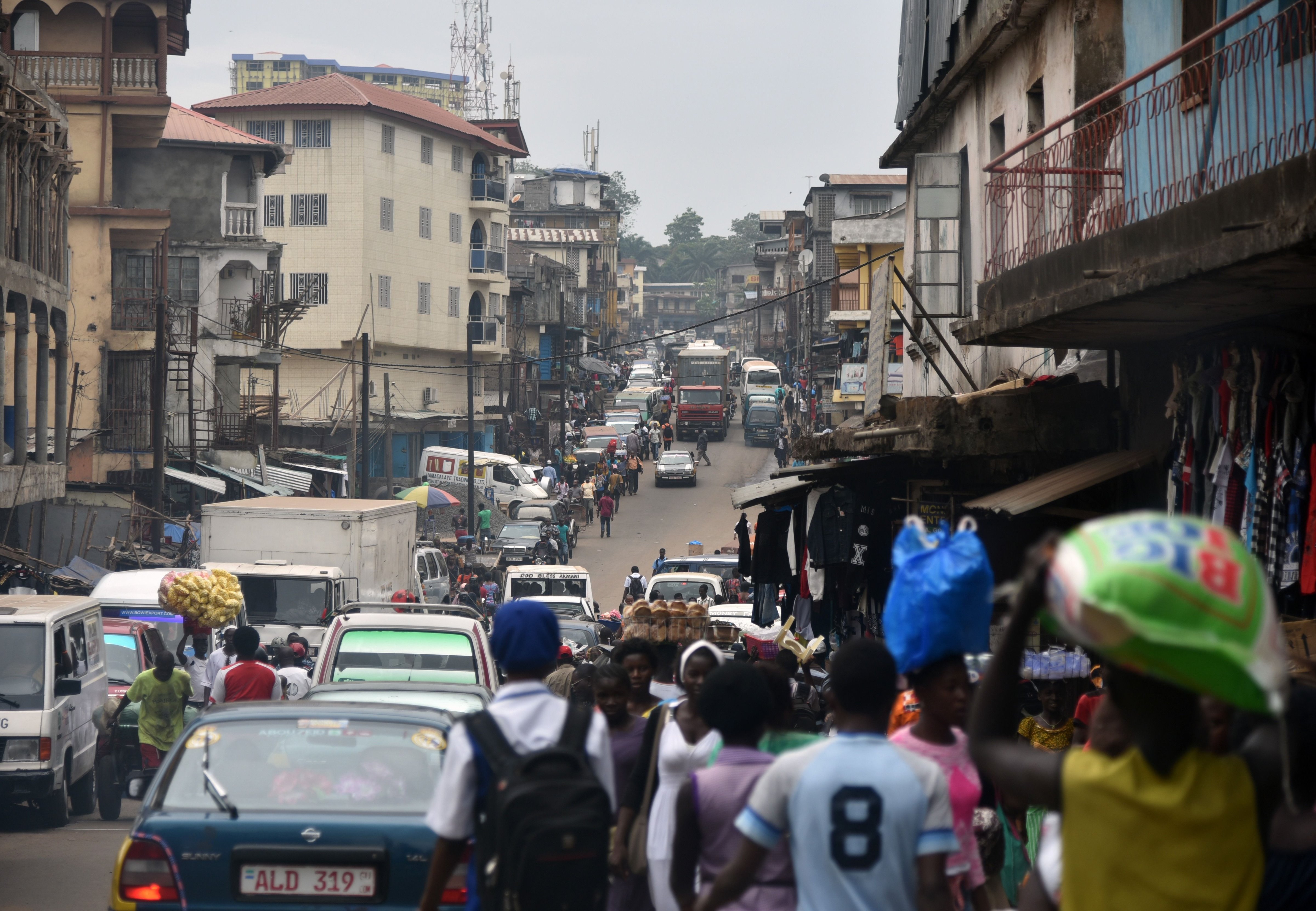People walk in the street of Freetown, Sierra Leone on Jan. 22, 2016. (Sia-Kambou—AFP/Getty Images)