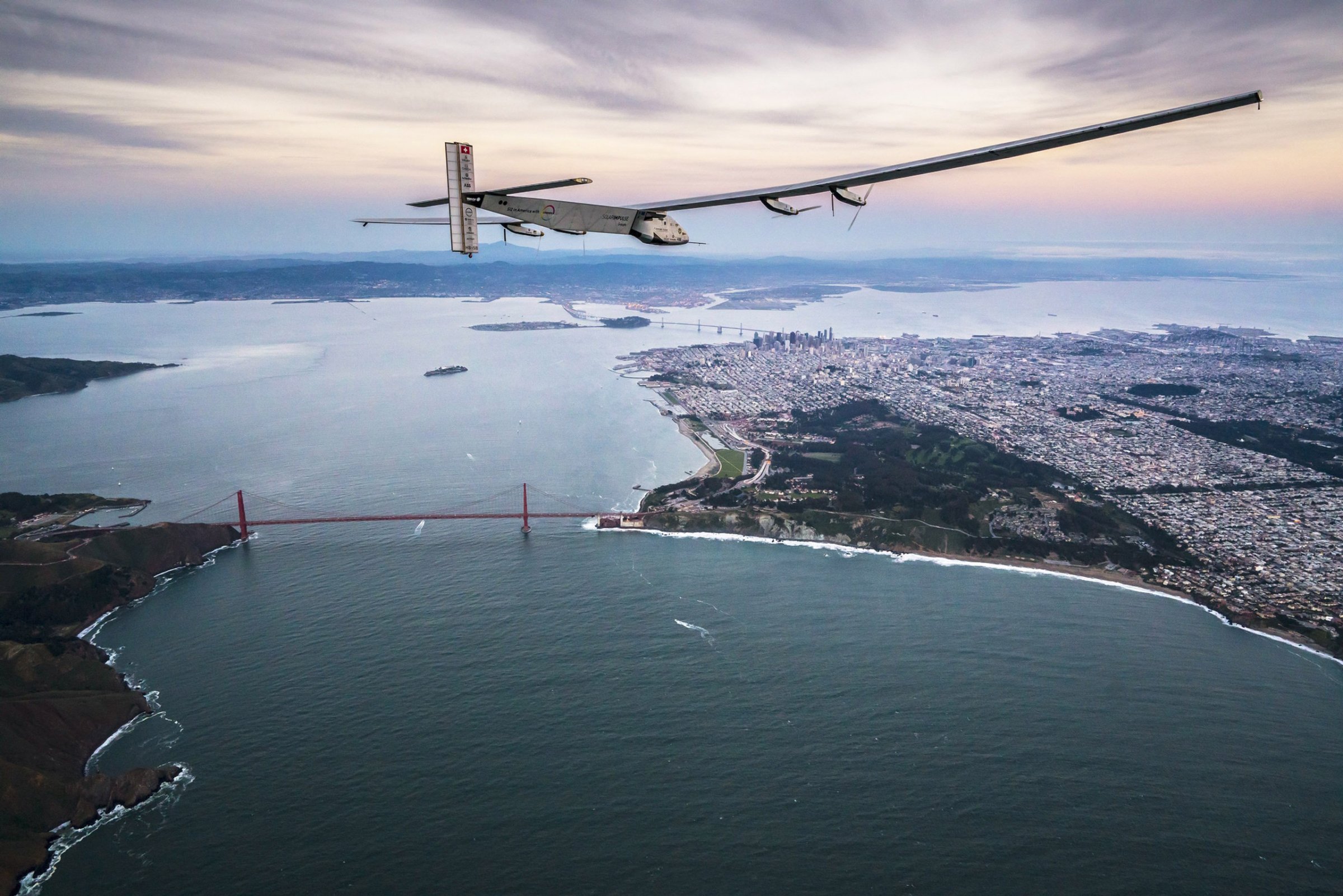 SAN FRANCISCO, CA - APRIL 23: In this handout image supplied by Jean Revillard, Solar powered plane 'Solar Impulse 2', piloted by Swiss adventurer Bertrand Piccard, flys over the Golden Gate bridge in San Francisco, after a flight from Hawaii during its circumnavigation, before landing at Moffett Airfield in Mountain View in Silicon Valley, on April 23, 2016 in San Francisco, California. The Solar Impulse 2 is equipped with 17,000 solar cells, has a wingspan of 72 metres, and yet weighs just over 2 tonnes. (Photo by Jean Revillard via Getty Images)