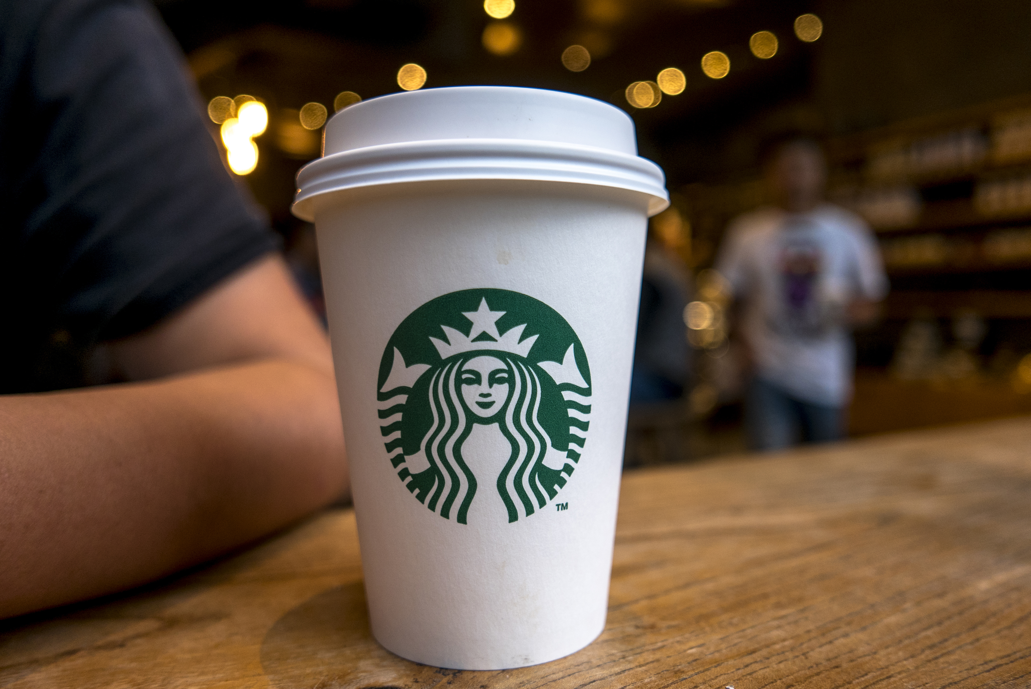 Coffee cup on table in a Starbucks cafe. (Zhang Peng&mdash;LightRocket/Getty Images)