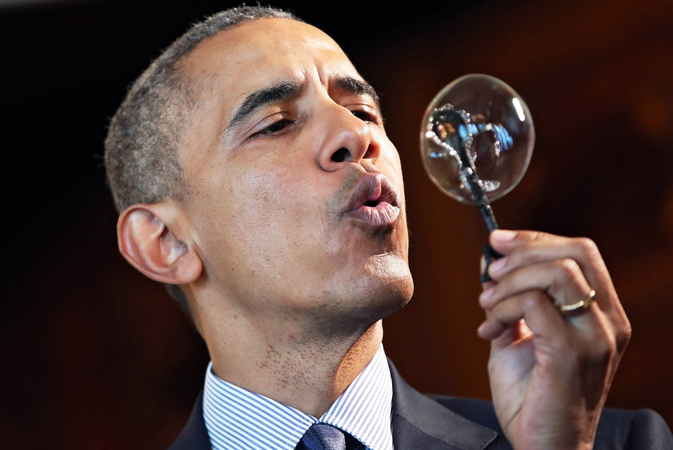 President Barack Obama blows a bubble from a wand made with a 3D printer by nine-year-old Jacob Leggette at the White House Science Fair in Washington on April 13, 2016.
