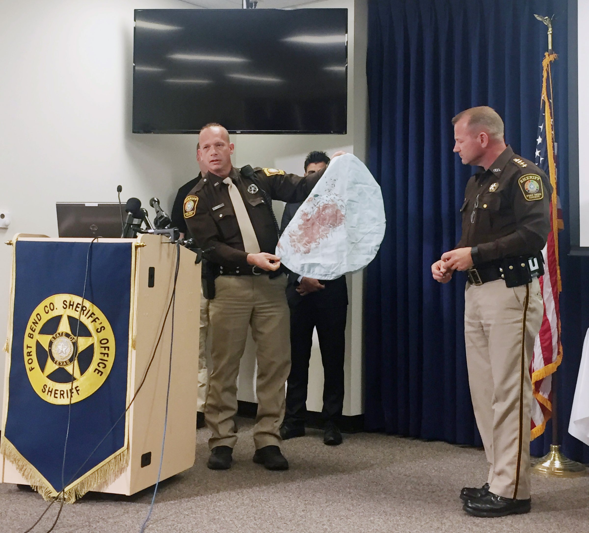 Deputy Danny Beckworth displays part of a defective airbag believed to have killed 17-year-old Huma Hanif during a news conference in Houston on April 7, 2016.
