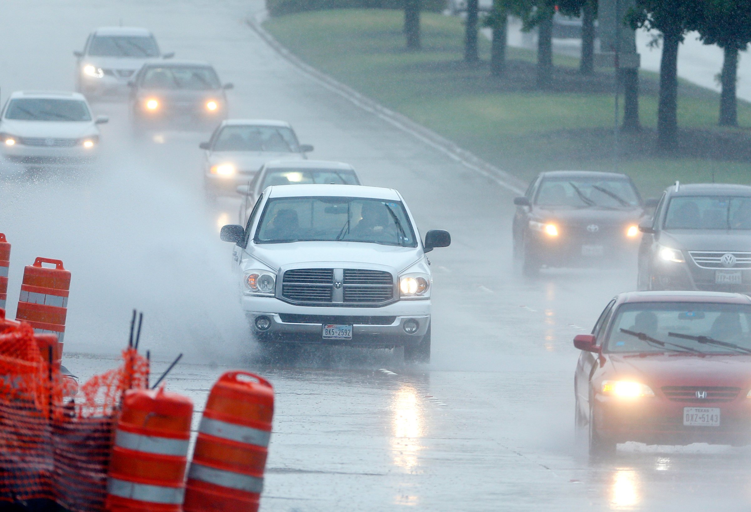 Drivers navigate through a heavy rain shower in Richardson, Texas, April 17, 2016.