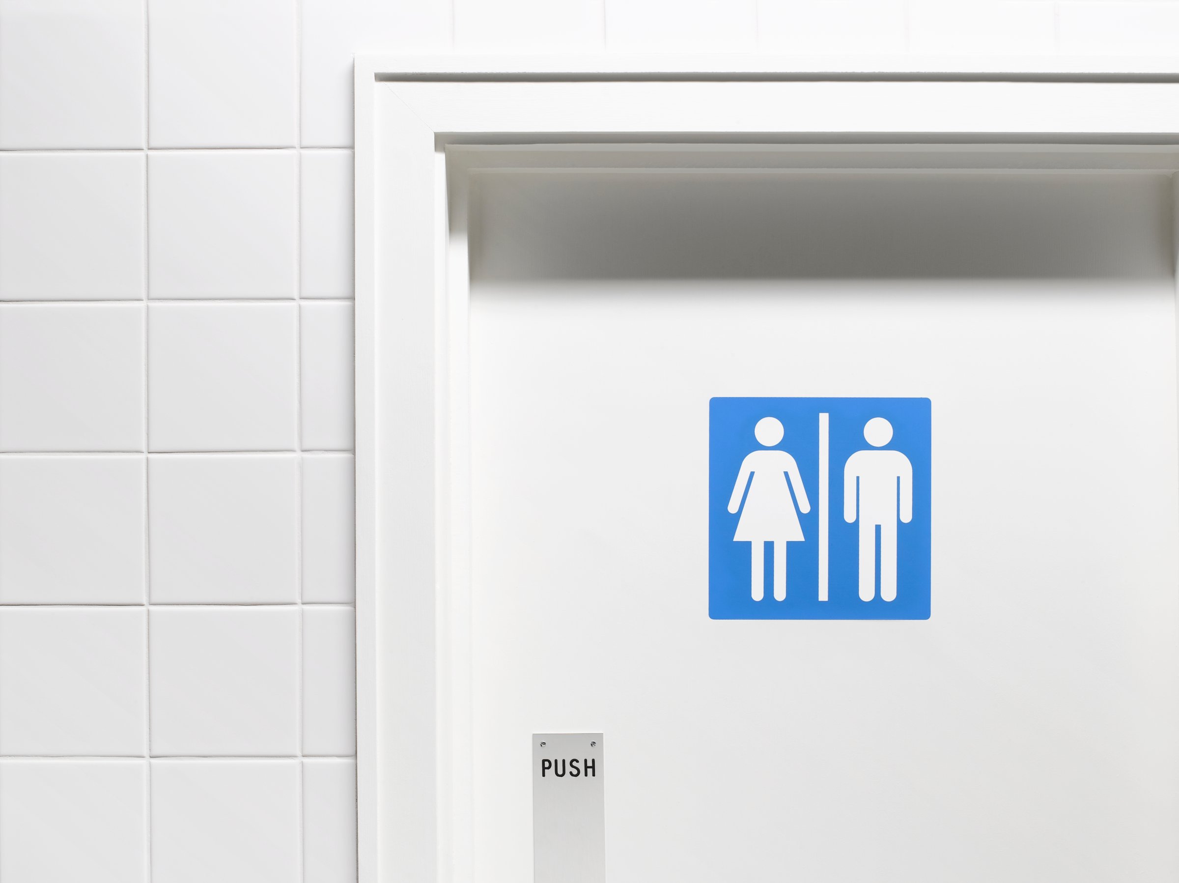 Female and male sign on toilet door, close-up