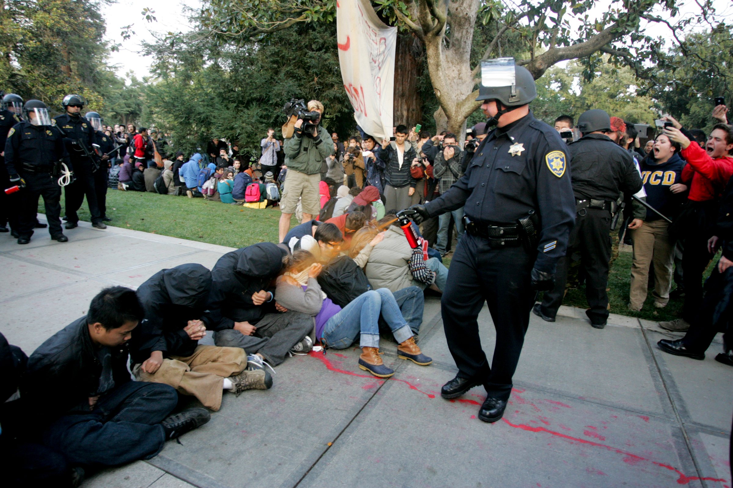A University of California Davis police officer pepper-sprays students during their sit-in at an "Occupy UCD" demonstration in Davis, Calif. on Nov. 18, 2011.