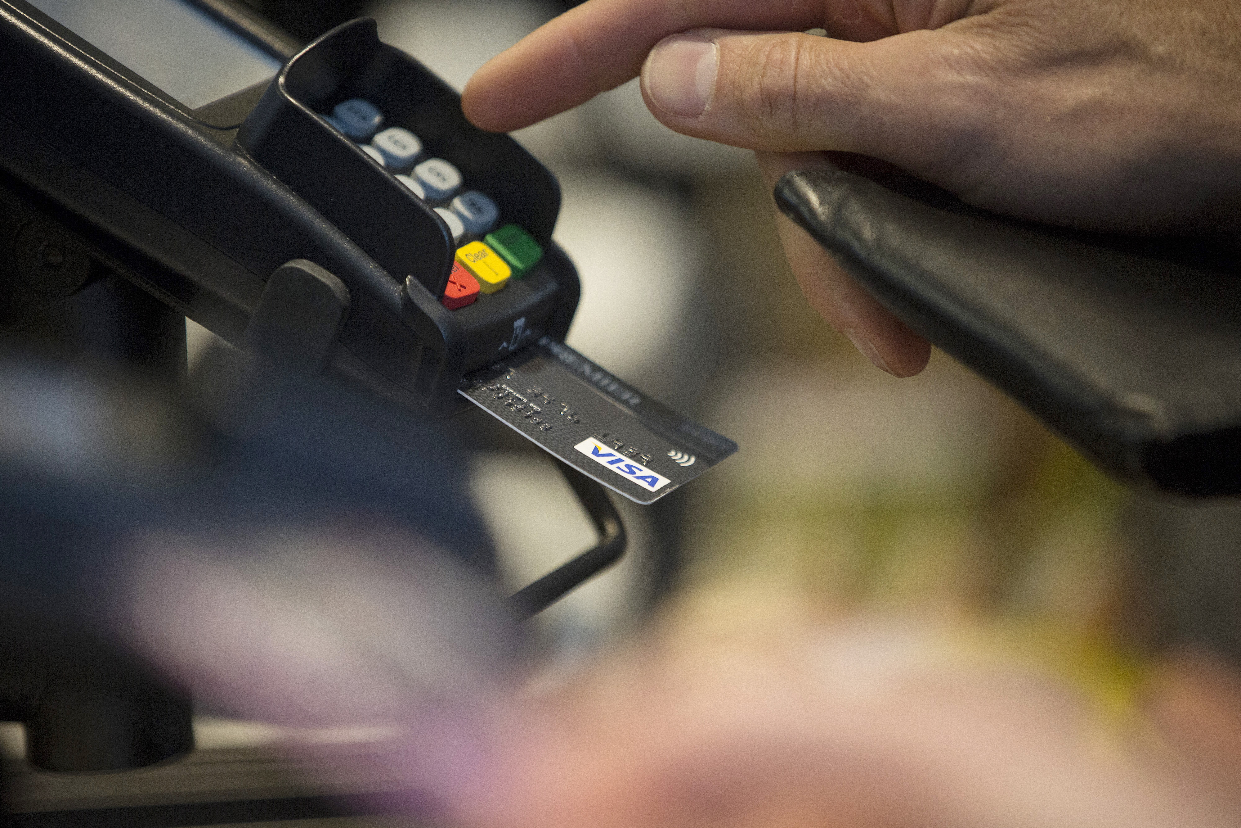 A customer enters their pin number while making a chip and pin payment using a Visa Inc. payment card. (Simon Dawson—Bloomberg/Getty Images)