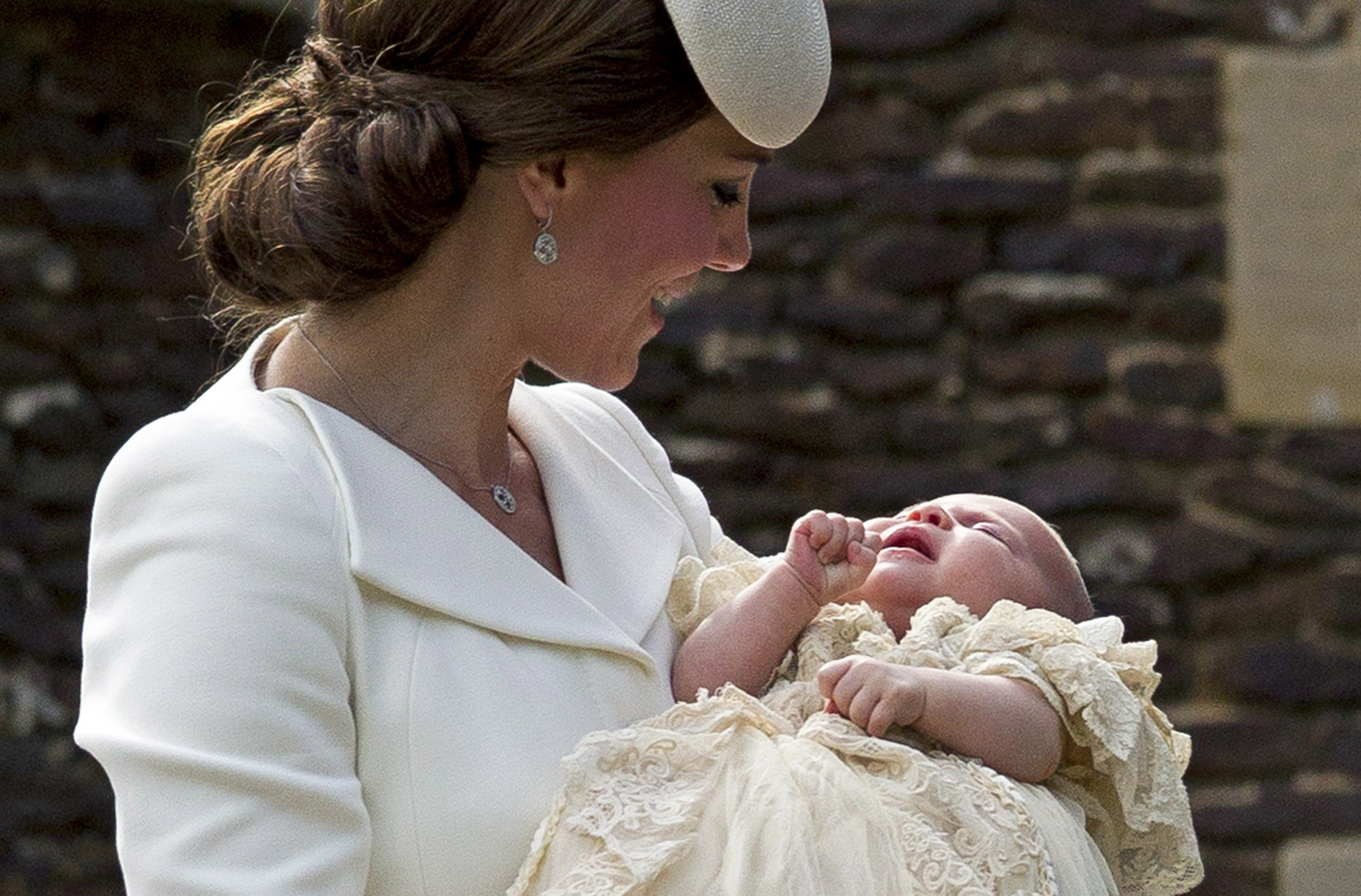 Catherine, Duchess of Cambridge, carries Princess Charlotte of Cambridge as they arrive at the Church of St Mary Magdalene on the Sandringham Estate for the Christening of Princess Charlotte of Cambridge in King's Lynn, England on July 5, 2015.