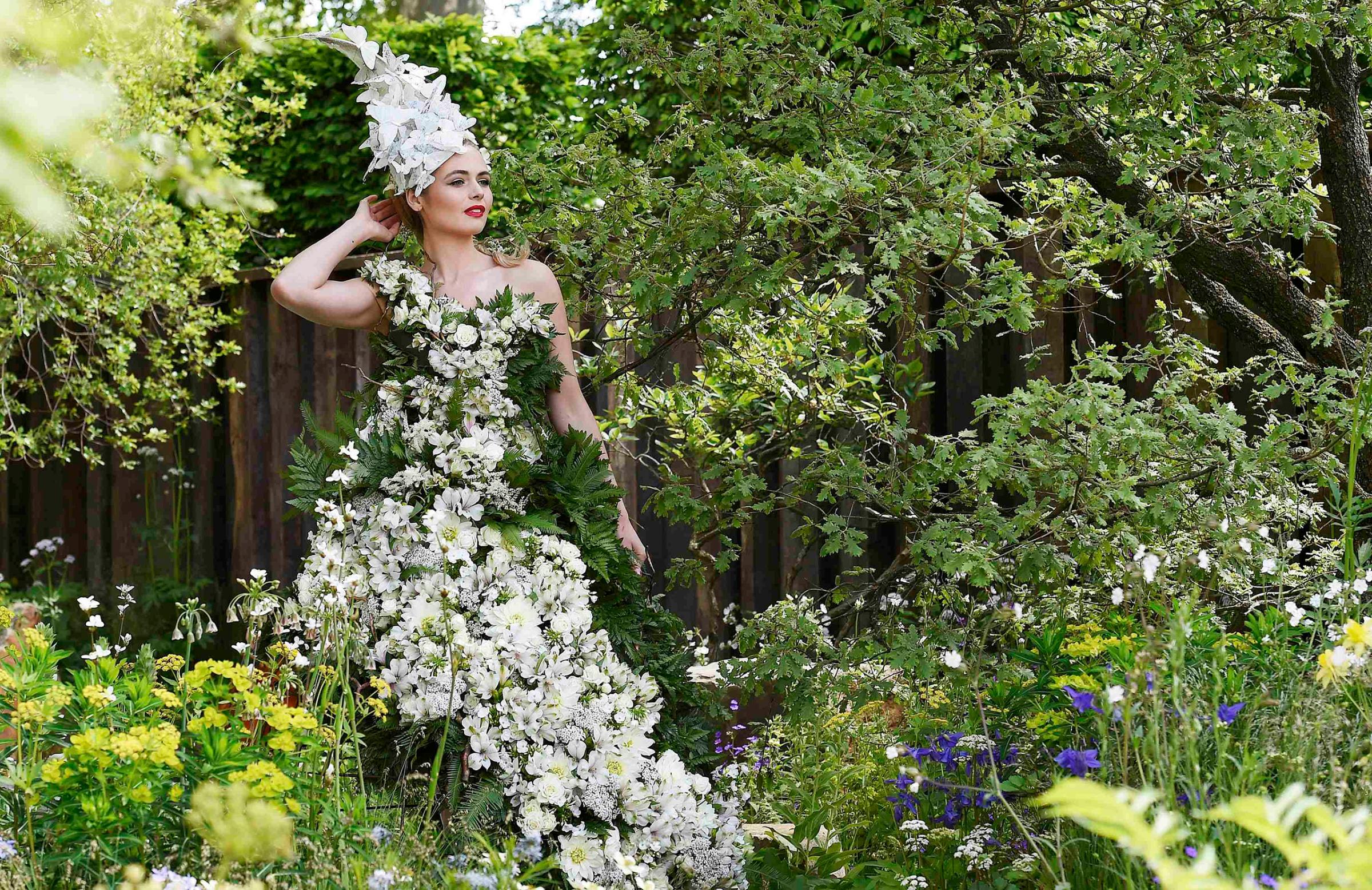 A model poses in a floral dress at the Chelsea Flower Show in London, Britain