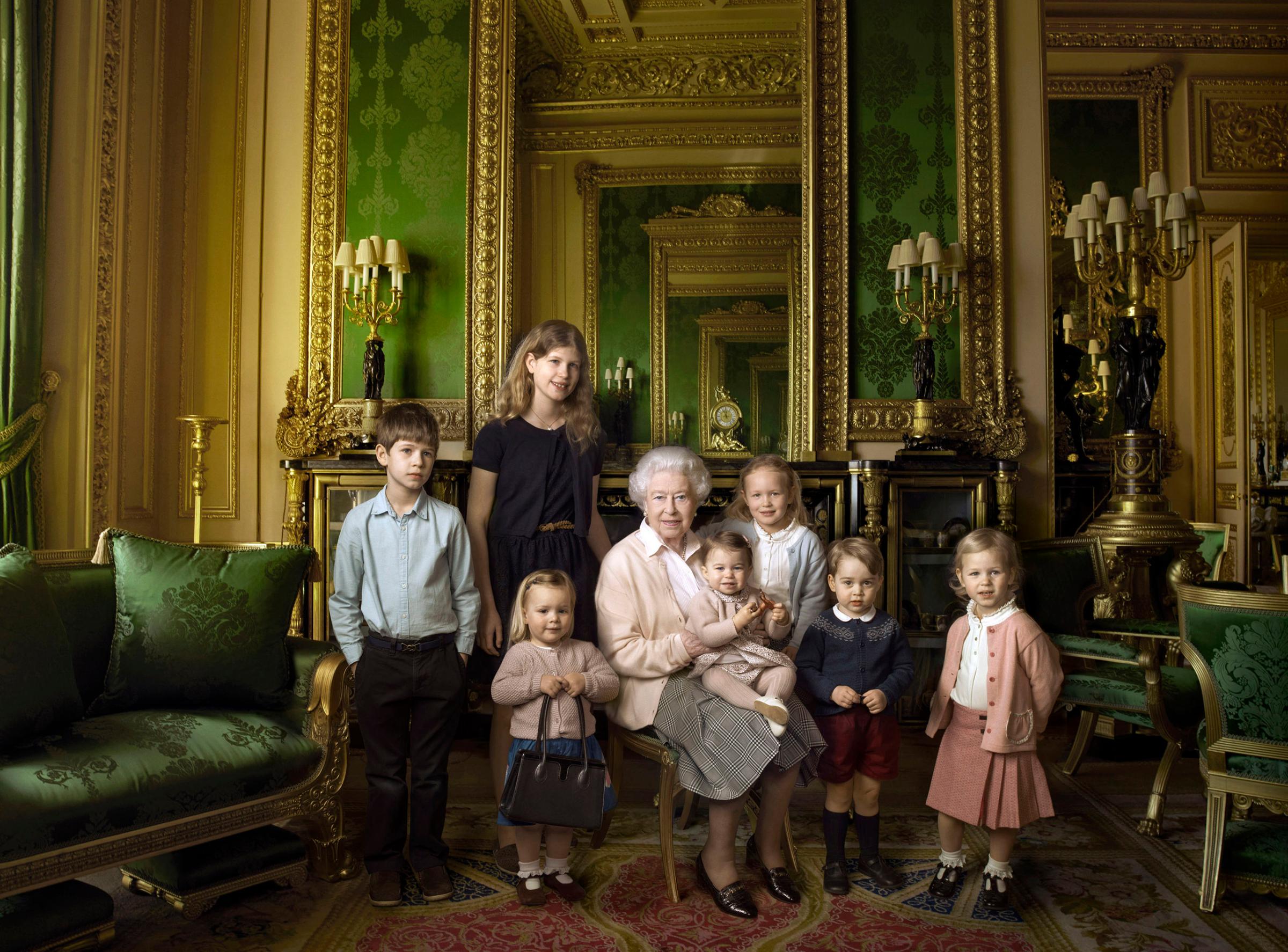 Queen Elizabeth II with her five great-grandchildren and her two youngest grandchildren in the Green Drawing Room, part of Windsor Castle's semi-State apartments in Windsor England. The children are: James, Viscount Severn, 8-years-old, left, and Lady Louise, 12-years-old, second left, the children of The Earl and Countess of Wessex; Mia Tindall, holding The Queen's handbag, the two year-old-daughter of Zara and Mike Tindall; Savannah 5-years-old, third right, and Isla Phillips, 3-years-old, right, daughters of The Queen's eldest grandson Peter Phillips and his wife Autumn; Prince George, 2-years-old, second right, and in The Queen's arms and in the tradition of Royal portraiture, the youngest great-grandchild, Princess Charlotte, 11-months-old, children of Prince William and Kate Duchess of Cambridge, April 20, 2016.