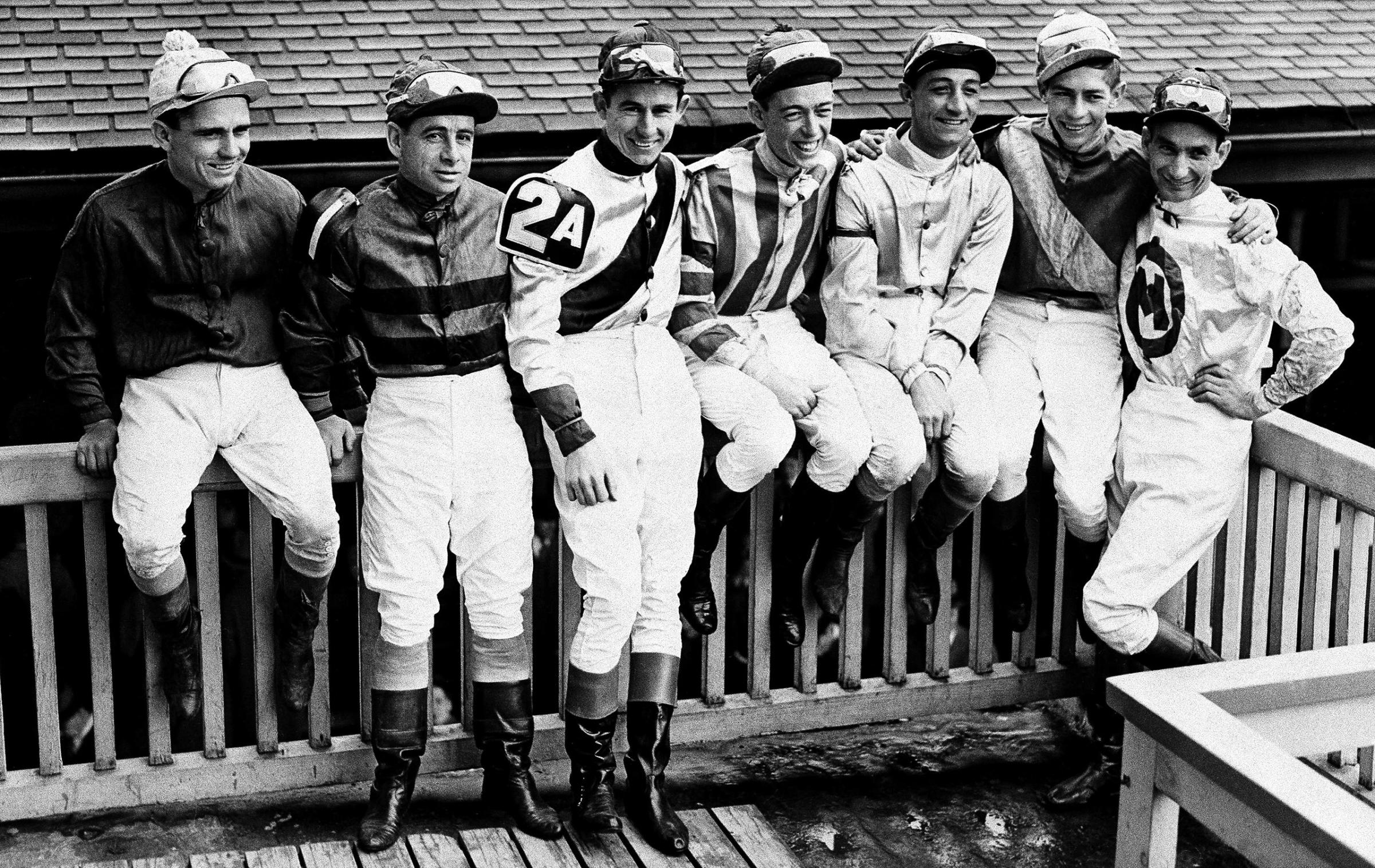 Seven of the Jockeys scheduled to ride in the 1947 Kentucky Derby sit on the rail at Churchill Downs after taking part in the Kentucky Oaks. L. To R., with horses they'll ride: Steve Brooks, Star Reward; Johny Longden, on trust; Eric Guerin, Jet Pilot; Shelby Clark, Cosmic Bomb; Eddie Arcaro, Phalanx; Job Jessop, Liberty road, and Will Balzaretti, Riskolater.