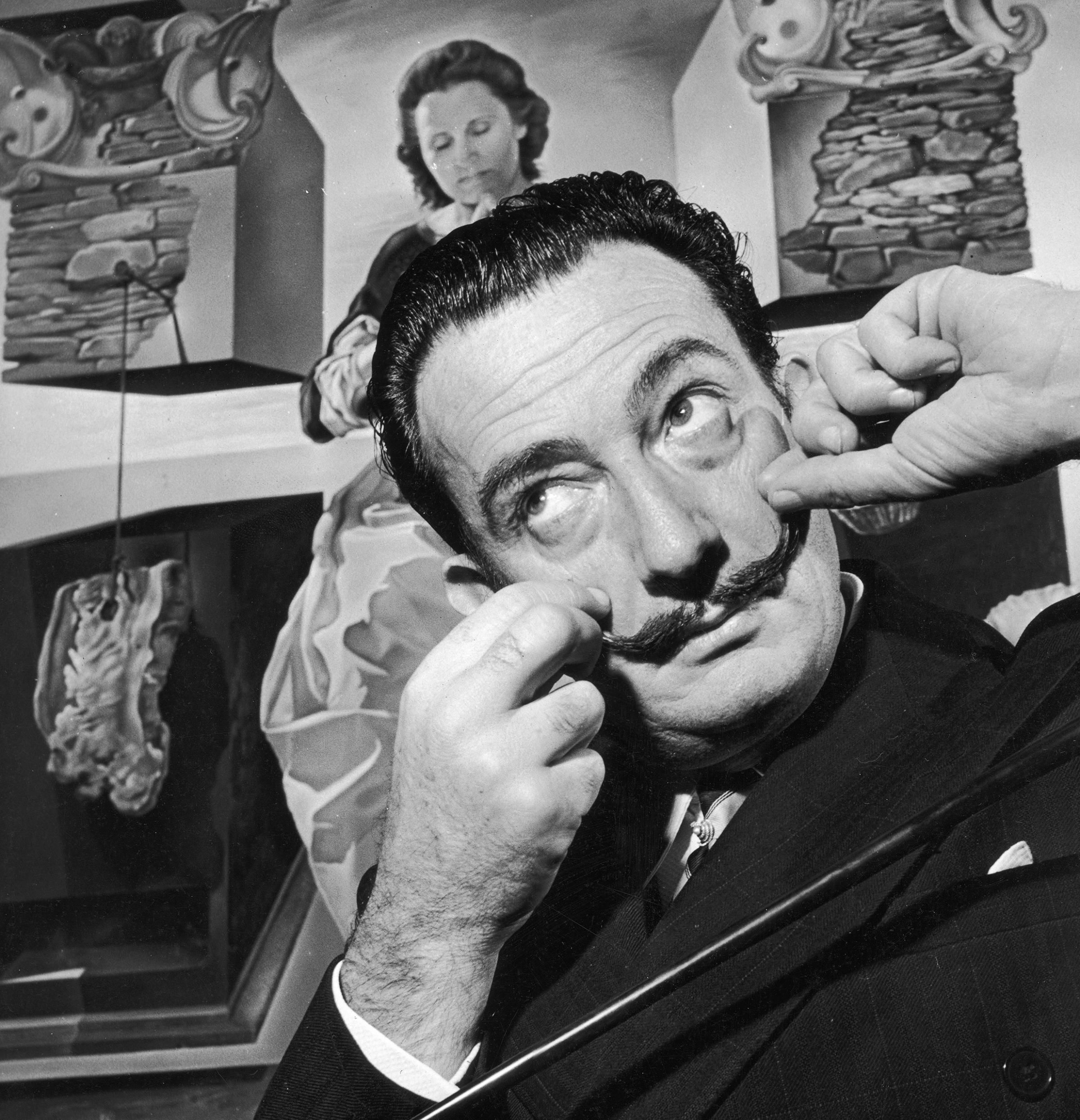 Salvador Dali in London with one of his paintings entitled 'The Madonna of Port Lligat', December 1951.