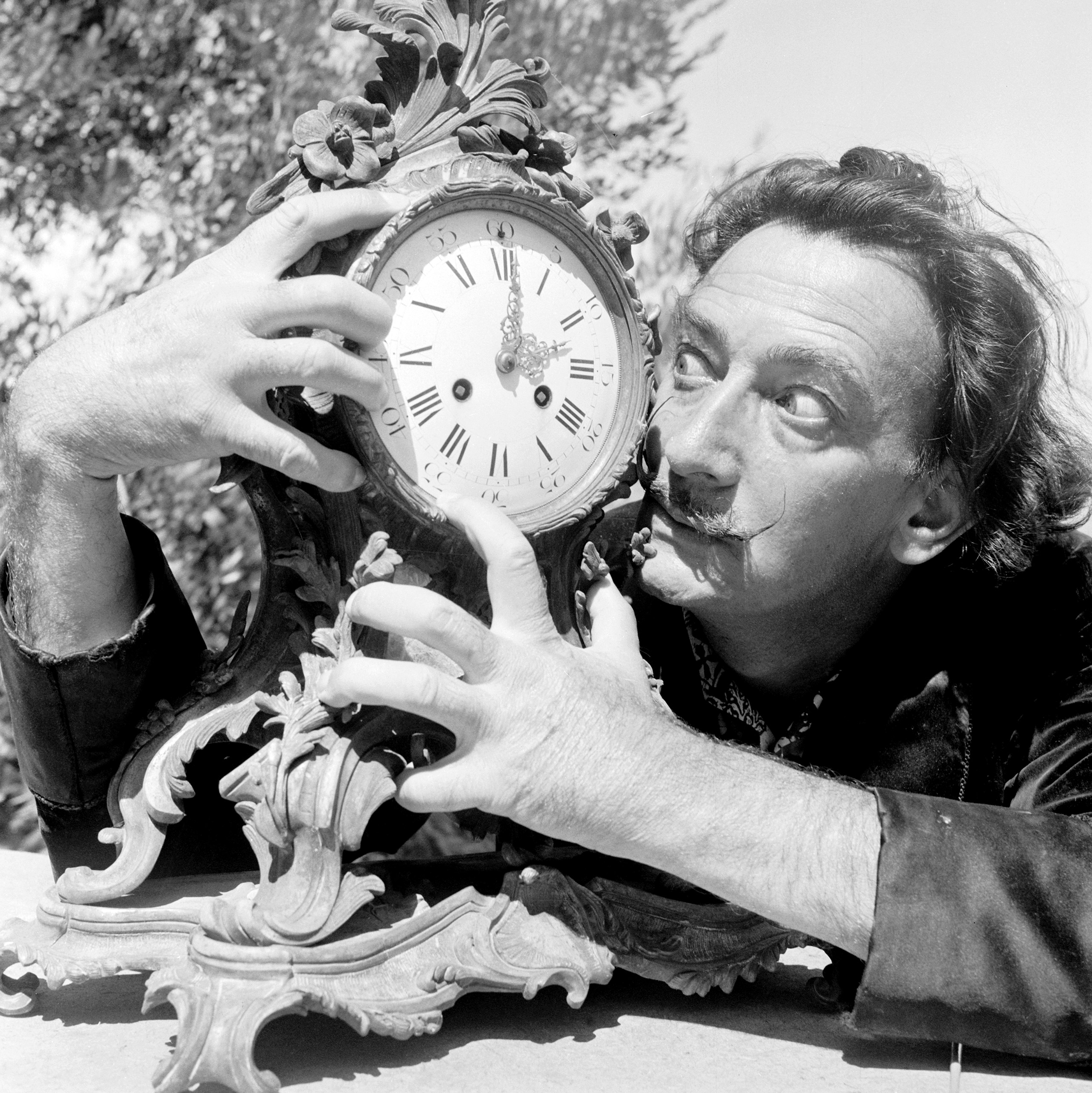Salvador Dali clutches an ornate clock at his home in Cadaques on the Costa Brava, Spain, Jan. 8, 1955.