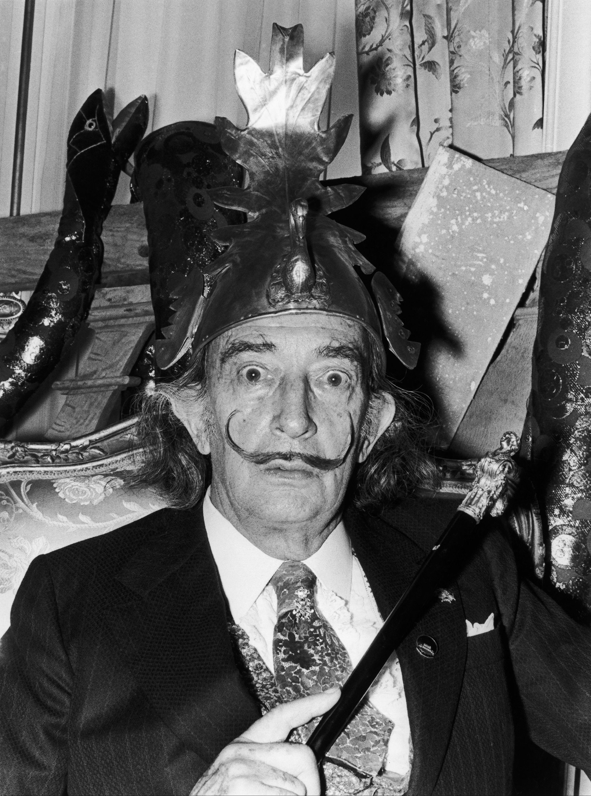 Salvador Dali wearing a helmet while presenting his first cylindrical chrono-hologram during a press conference in his Spanish apartment, on May 21, 1973.