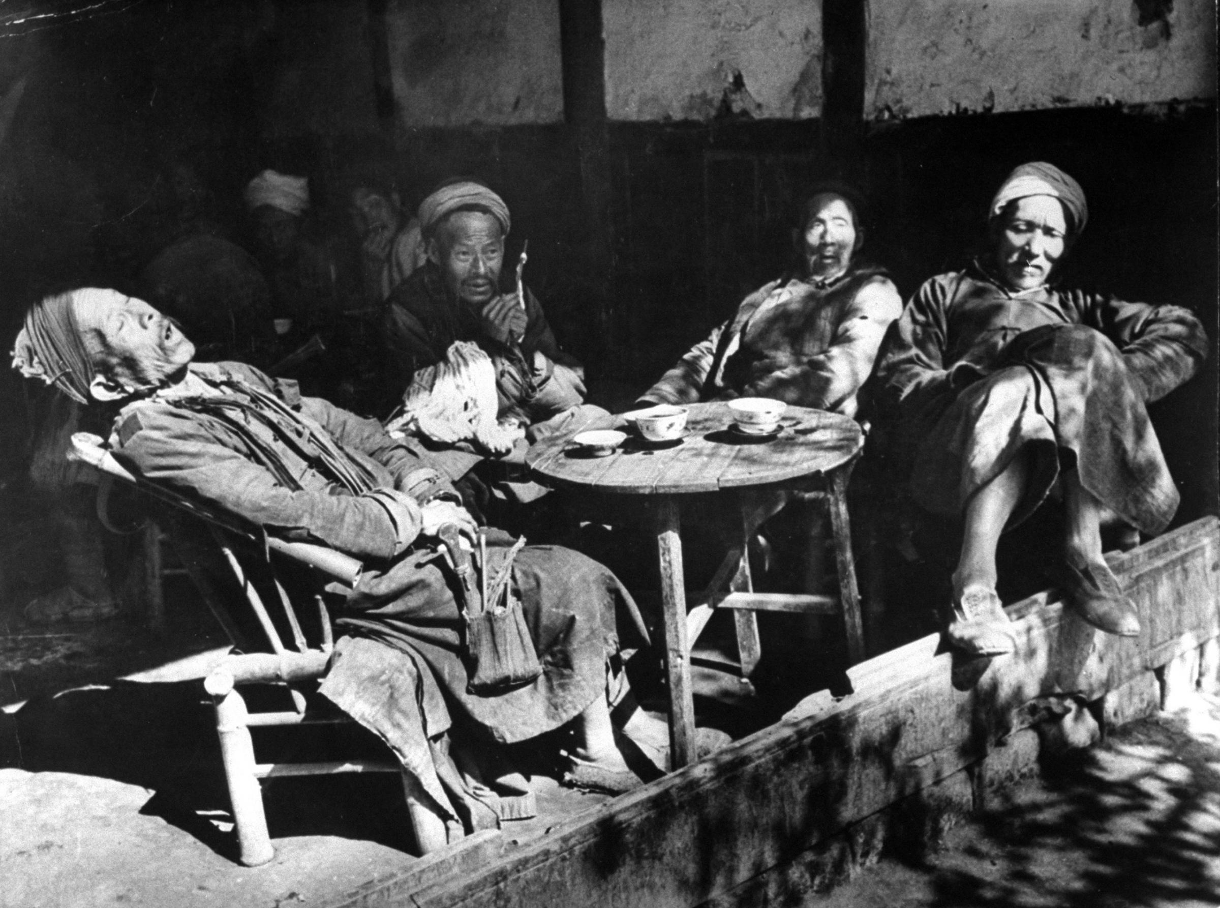 Old farmers relaxing at a Szechuan teahouse after market day in a village near Chengtu. This image appeared in the May 1, 1944 feature: "LIFE" Looks at China—Through the blockade one of its correspondents brings this firsthand report.