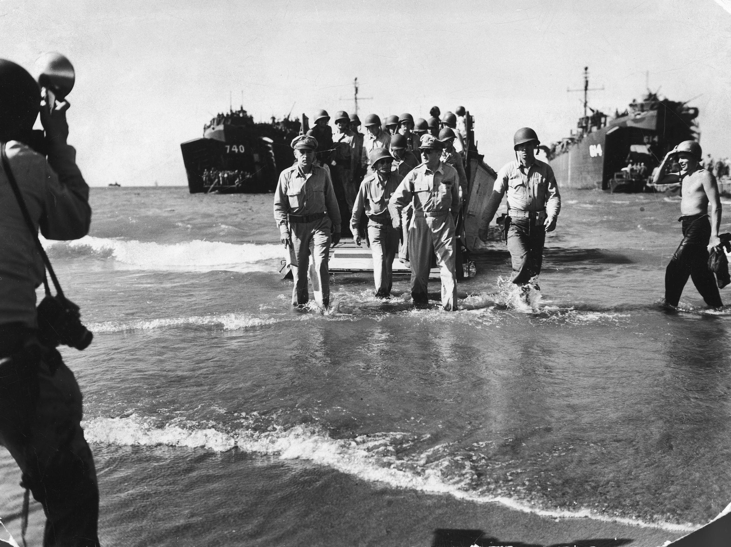 Gen. Douglas MacArthur (C), Gen. Richard Sutherland (L) and Col. Lloyd Lehrbas (2L) wading ashore during American landing at Lingayen Gulf. This image appeared in the February 19, 1945 photo essay: U.S. Wins Heart of the Phillippines.