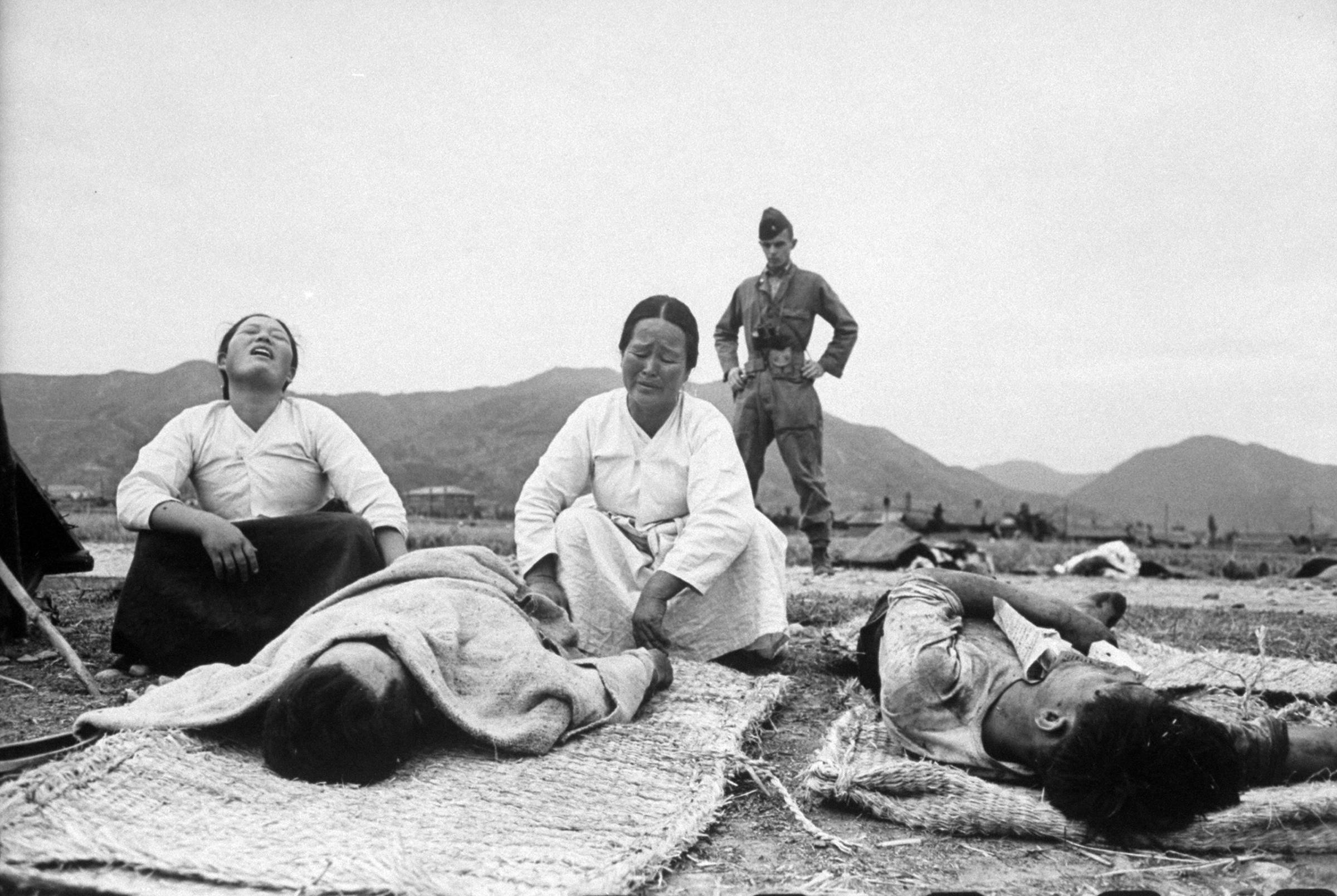 Two of Sunchon's bereaved women mourn a loyal Korean who fell before a rebel slaughter squad as the rebellion began. This image appeared in the Nov. 15, 1948 photo essay: Revolt in Korea—A New Communist uprising turns men Into butchers.