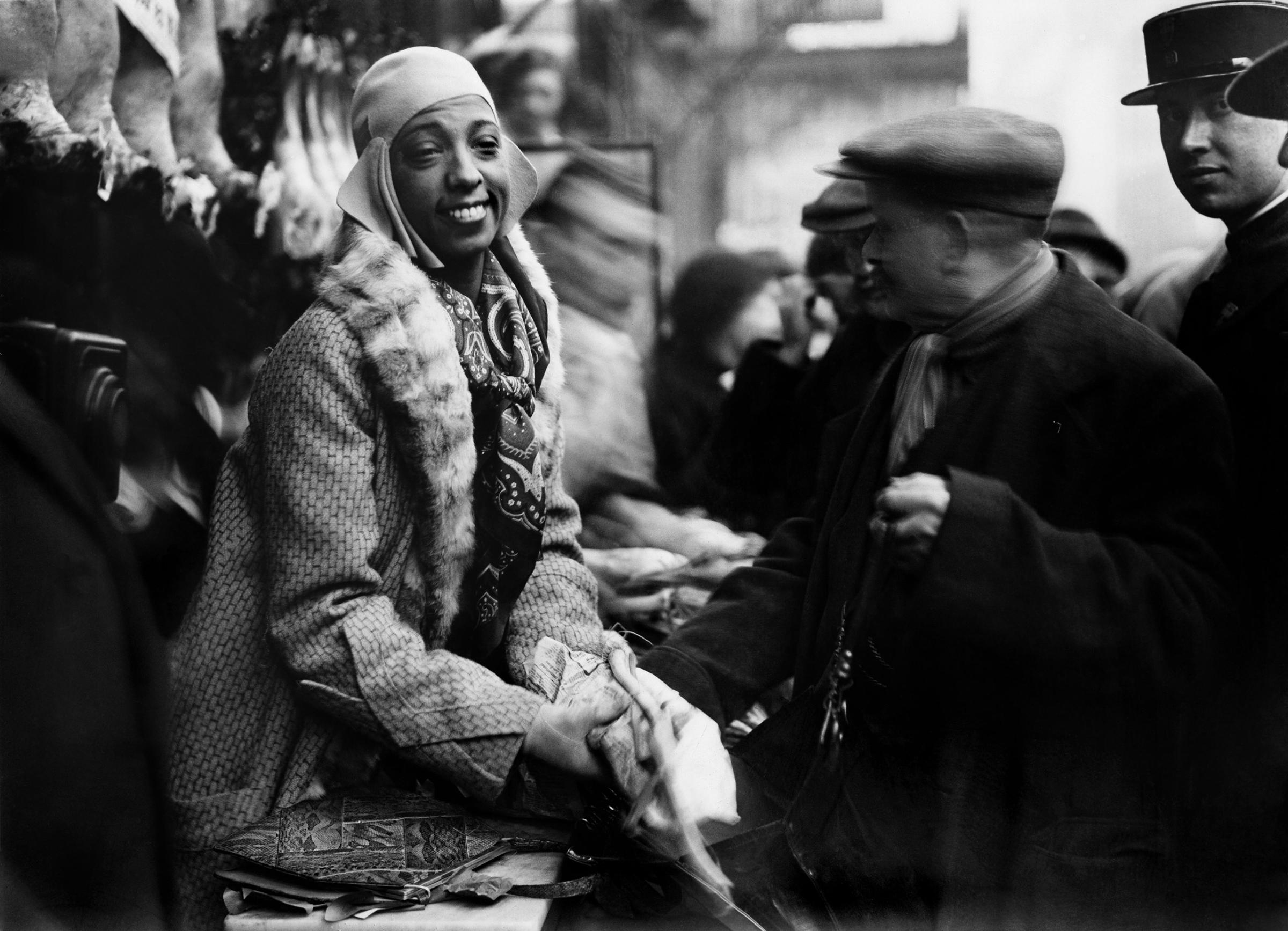 Josephine Baker distributes food to needy in Monmartre, Paris, 1930.