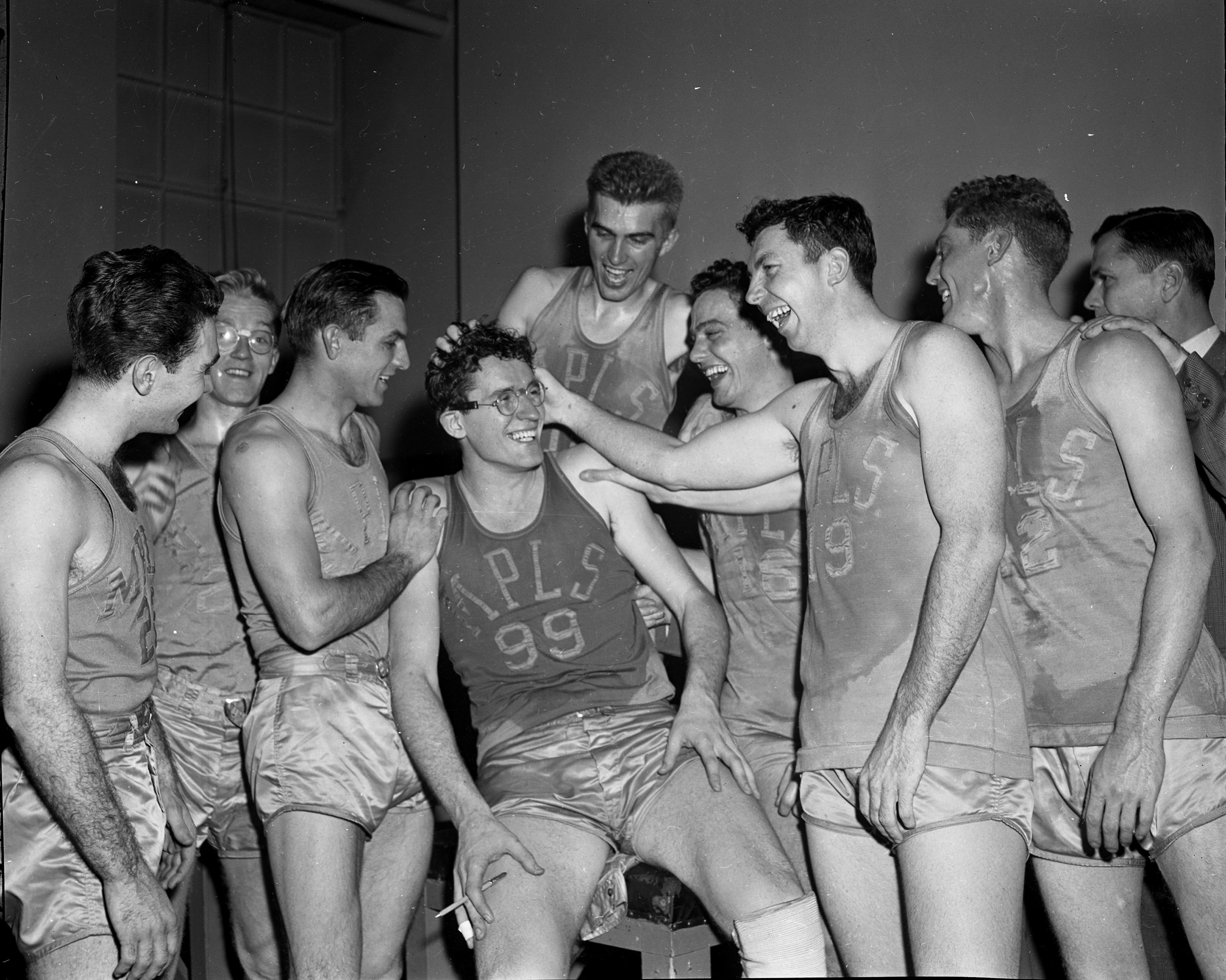 Minneapolis Lakers teammates congratulate George Milken after the 6-foot 10-inch wizard racked up 48 points in a 101-74 victory against the New York Knicks at Madison Square Garden. Feb. 23, 1949.