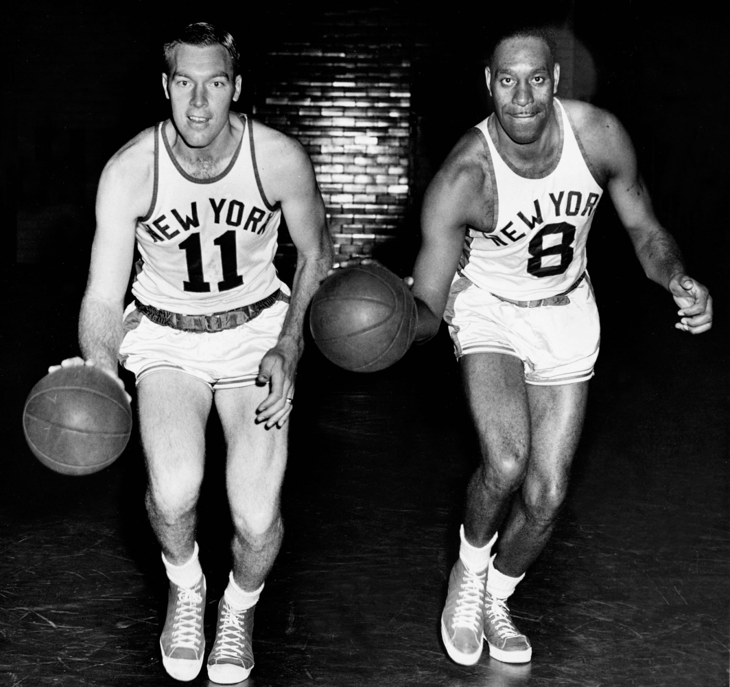 Harry Gallatin #11 and Nathaniel Clifton #8 of the New York Knicks pose for portrait circa 1950 in New York, New York.