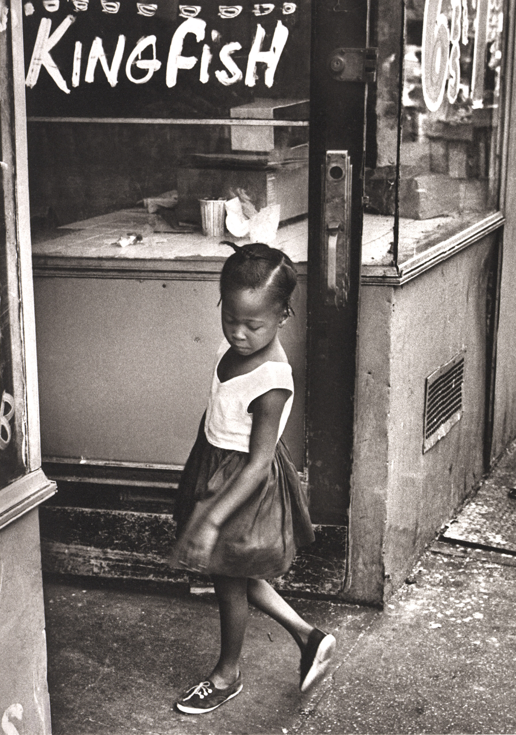 Young girl on DeKalb Avenue in Brooklyn, New York. 1965.