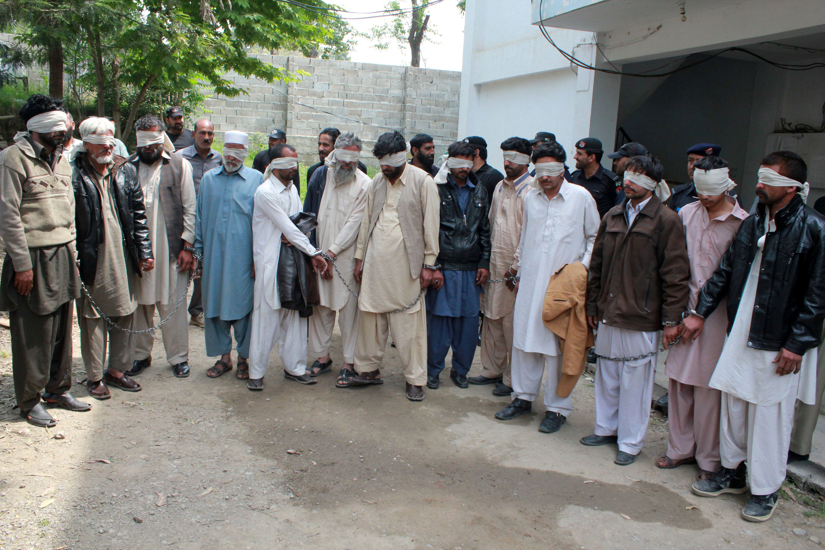 Members of a tribal council accused of ordering the burning death of a 16 year old girl are shown to the media after they were arrested by police in Donga Gali, outside Abbottabad