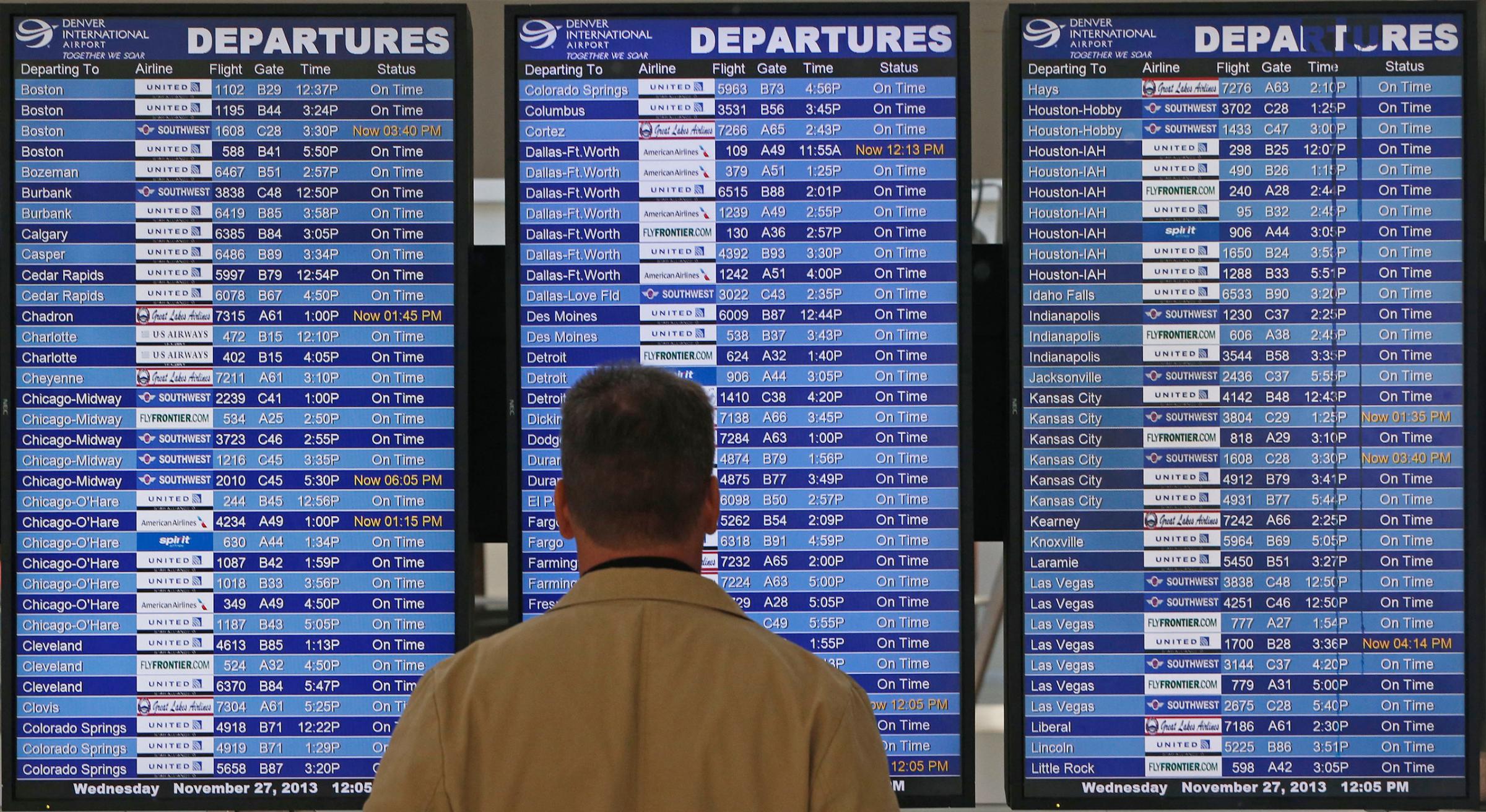 On the busiest travel day of the year, a passenger checks the departures board in a terminal at Denver International Airport, Wednesday, Nov. 27, 2013. More than 43 million people are to travel over the long holiday weekend, according to AAA. (AP Photo/Brennan Linsley)