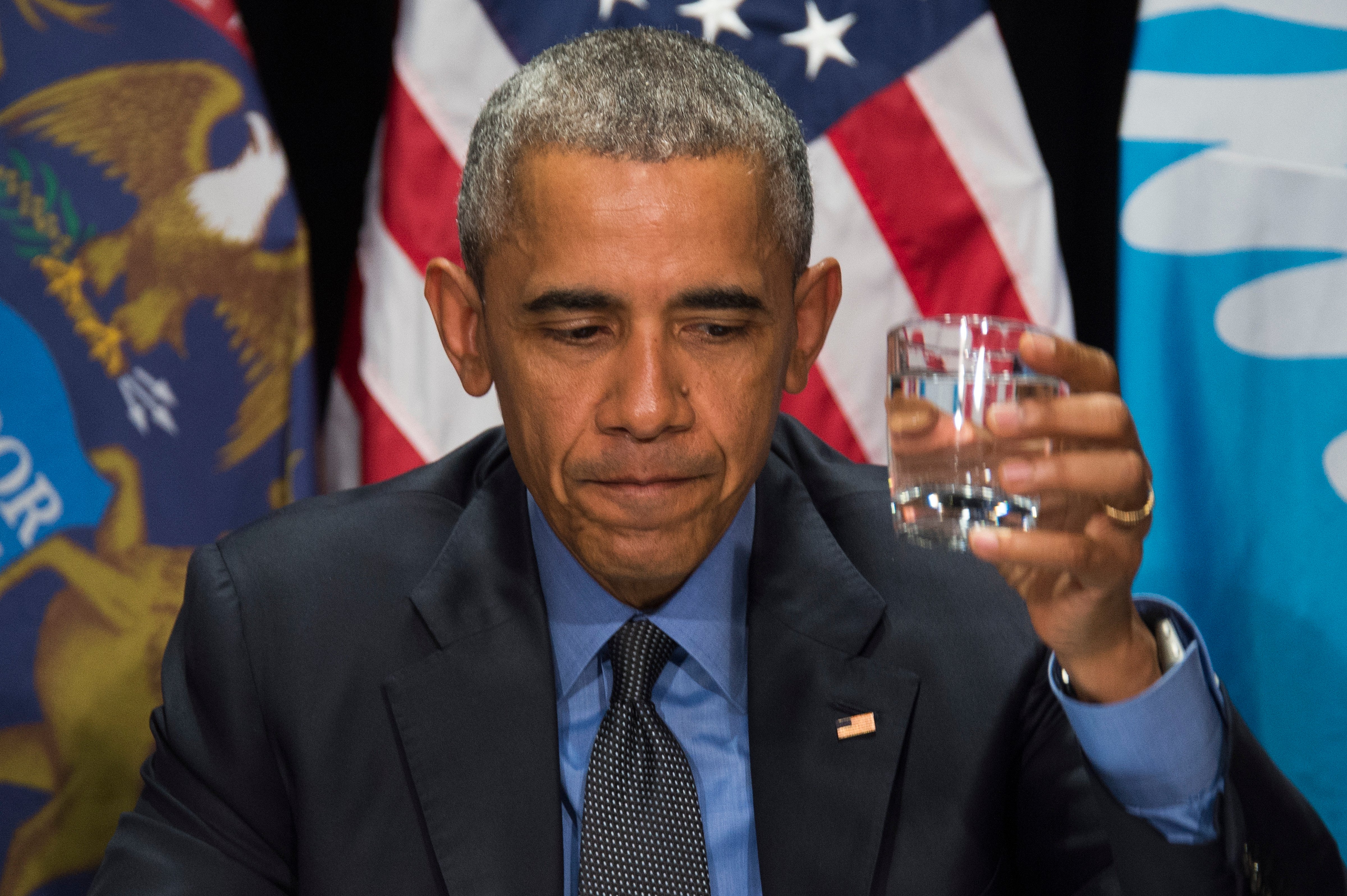 President Barack Obama drinks filtered water during a meeting at the Food Bank of Eastern Michigan in Flint, on May 4. (Jim Watson—AFP/Getty Images)