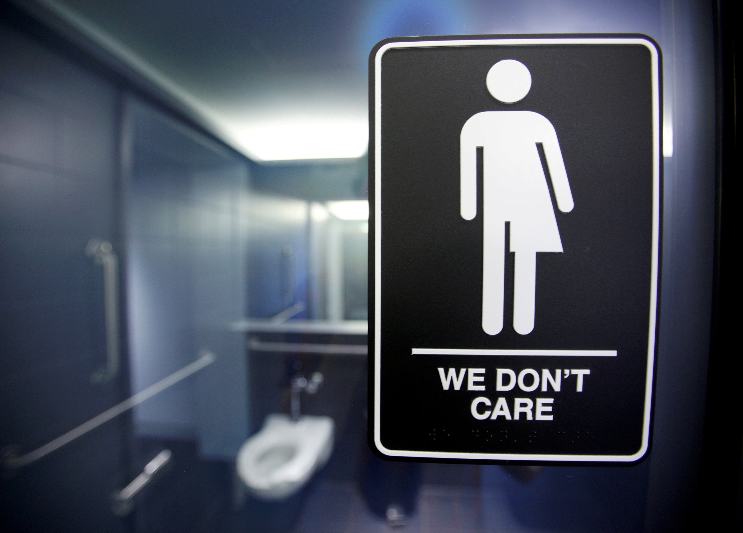 A sign protesting a recent North Carolina law restricting transgender bathroom access is seen in the bathroom stalls at the 21C Museum Hotel in Durham, North Carolina May 3, 2016.