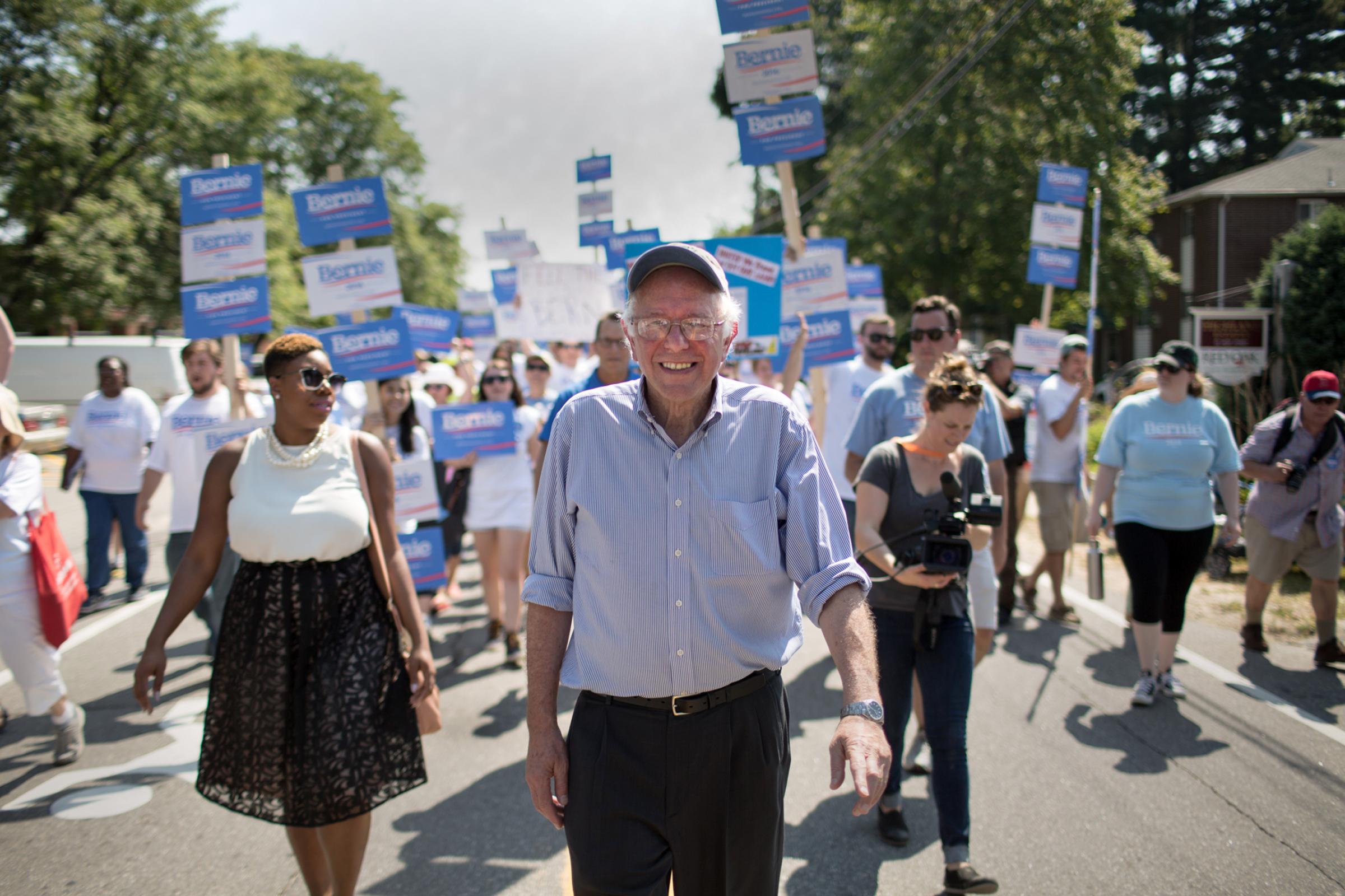 Senator Bernie Sanders and his national press secretary Symone Sanders (no relation) march in the Labor Day parade in Milford, NH.