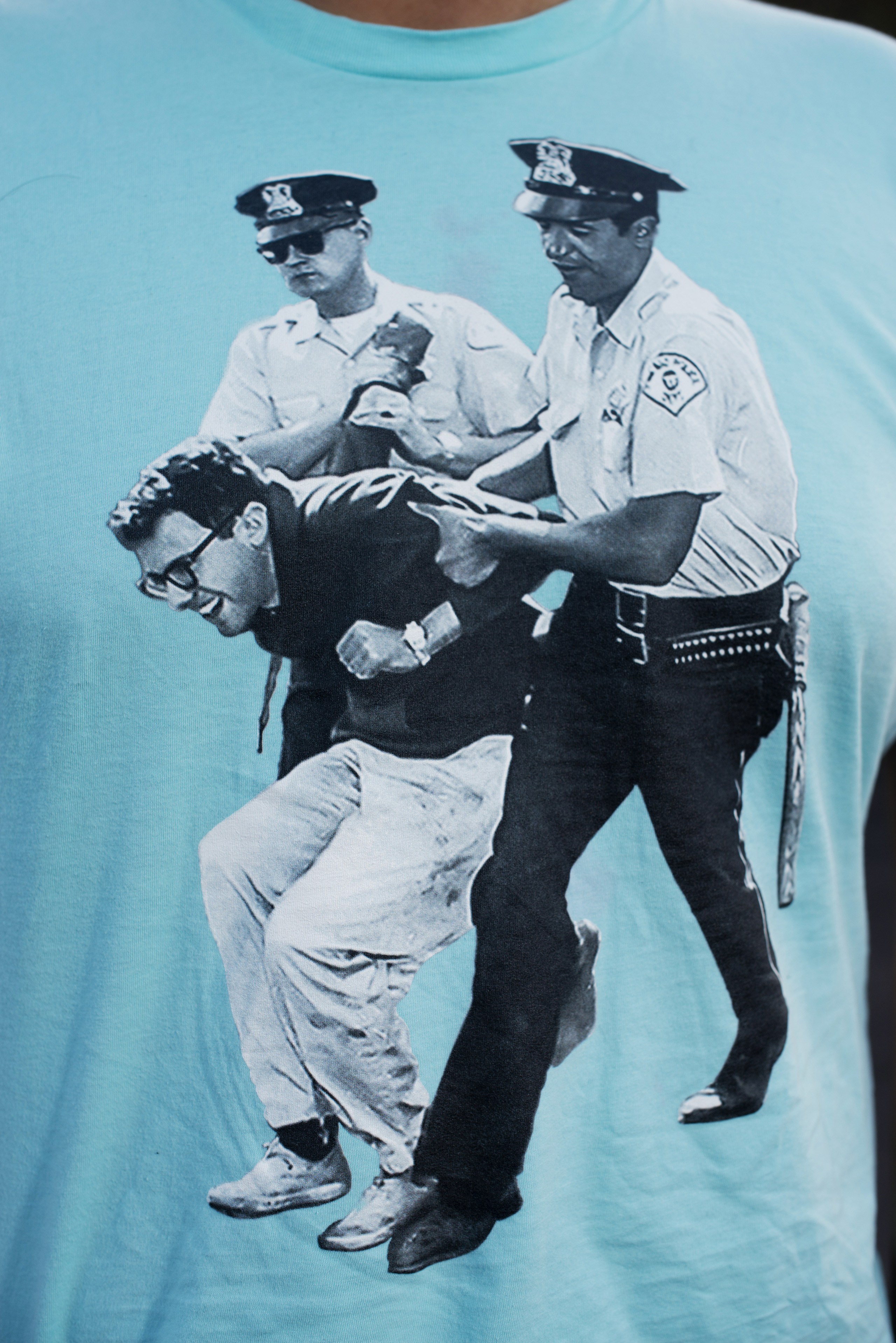 Detail of a Bernie Sanders supporter's t-shirt at a campaign rally at Irvine Meadows Amphitheatre in Irvine, Calif., May 22, 2016. The t-shirt shows an image of 21-year-old Sanders being arrested at a protest in Chicago in 1963.