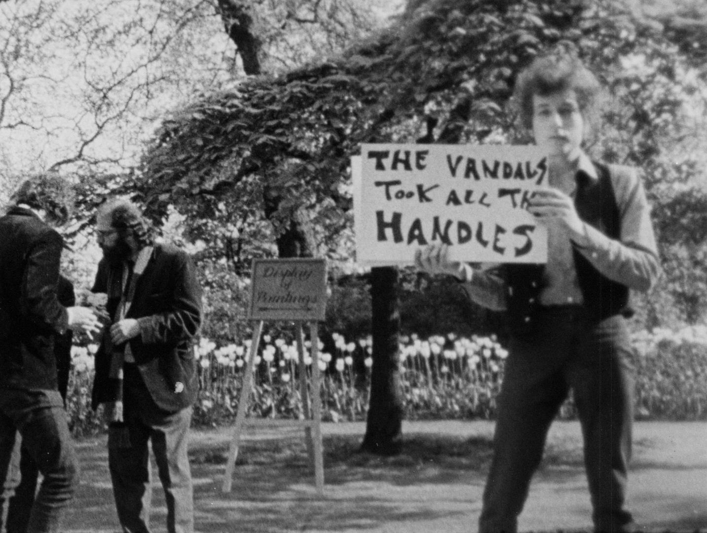 Bob Dylan during an alternate take of the "Subterranean Homesick Blues" scene from Don't Look Back in the Embankment Gardens in London, 1965.