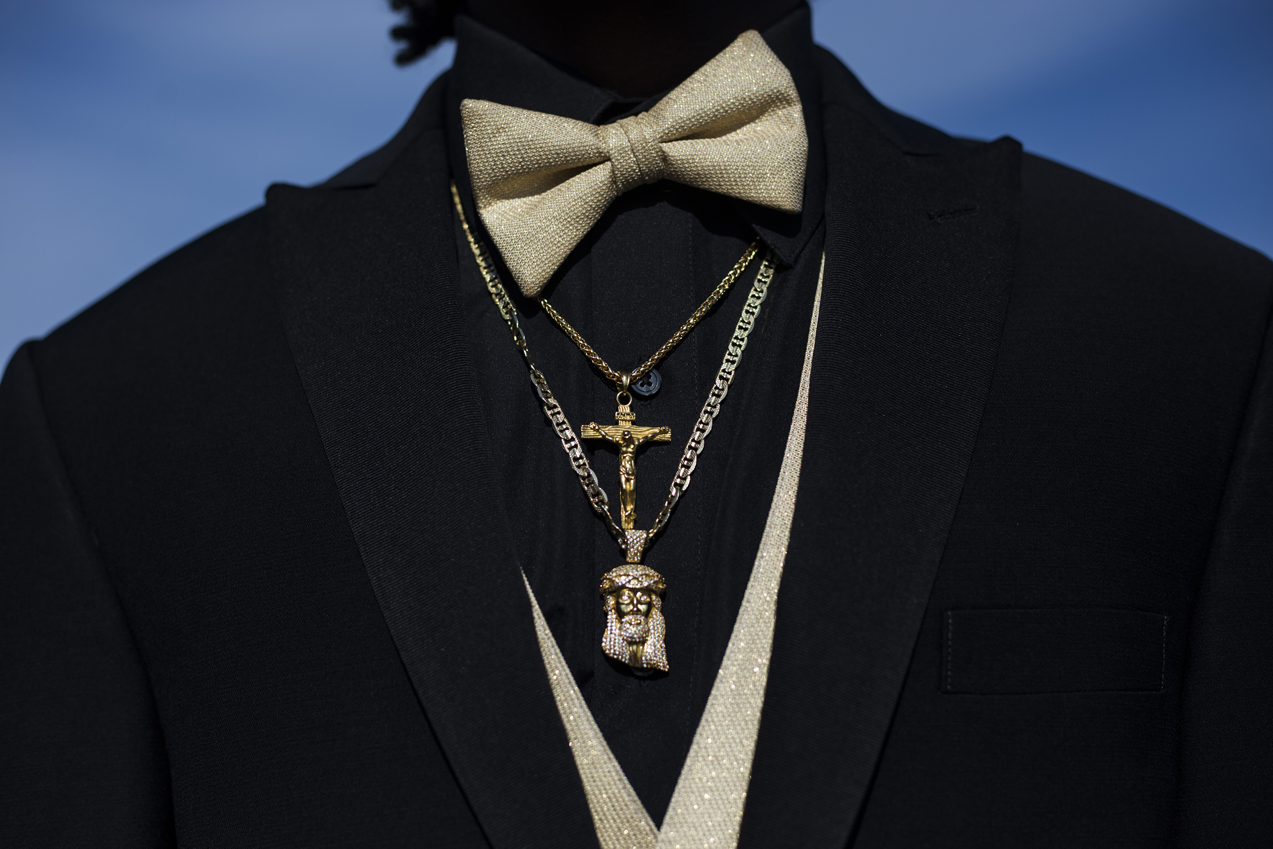 Mattek Scott, 18, sports a gold cross and Jesus pendant during a pre-prom red carpet-style event outside Northwestern High School in Flint, Mich., May 21, 2016.