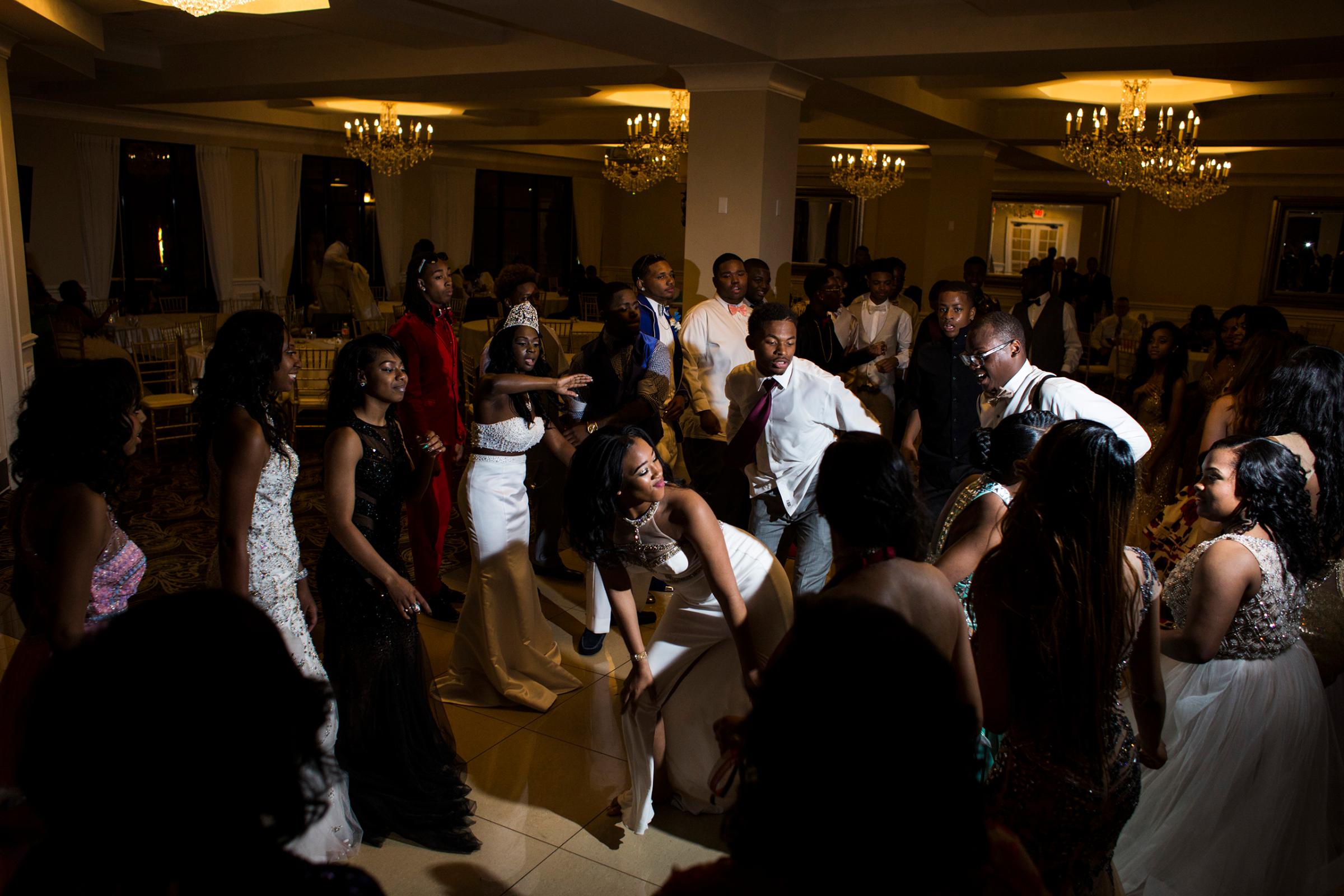 Students dance during a soul train line during prom at the Signature Chop House in Flushing, Mich., May 20, 2016.