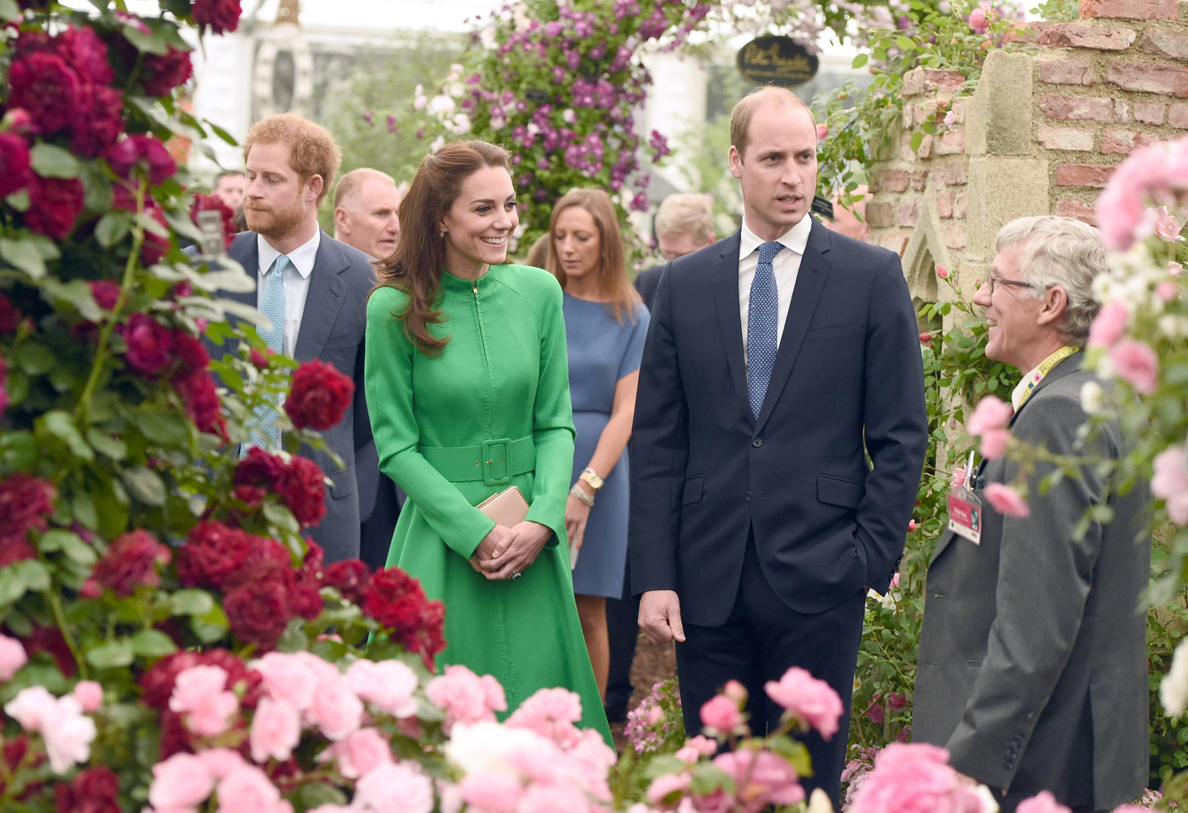 Prince William and Catherine, Duchess of Cambridge, are joined by Prince Harry during a visit to the 2016 Chelsea Flower Show in London on May 23, 2016.