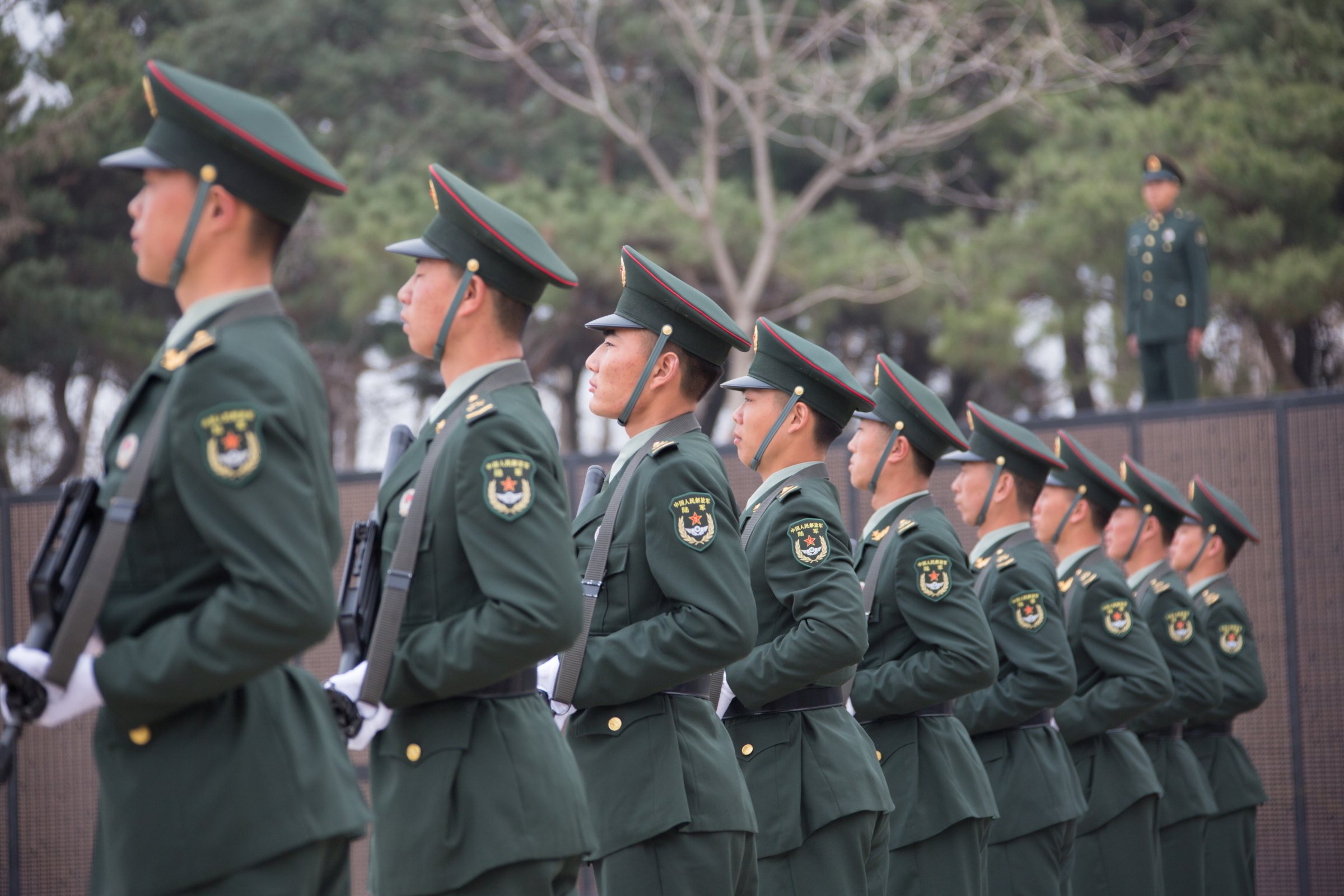 People's Liberation Army officers stand guard as a burial ceremony for the remains of 36 Chinese soldiers who died in the Korean War is held early morning at Korean War Martyrs' Cemetery on April 1, 2016 in Shenyang, Liaoning Province of China.