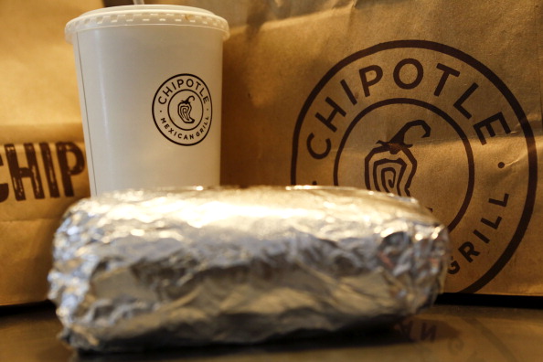 A steak burrito is arranged for a photograph with a drink and bags of chips at a Chipotle Mexican Grill Inc. restaurant in Hollywood, California, U.S., on Tuesday, July 16, 2013. (Patrick T. Fallon/Bloomberg via Getty Images)