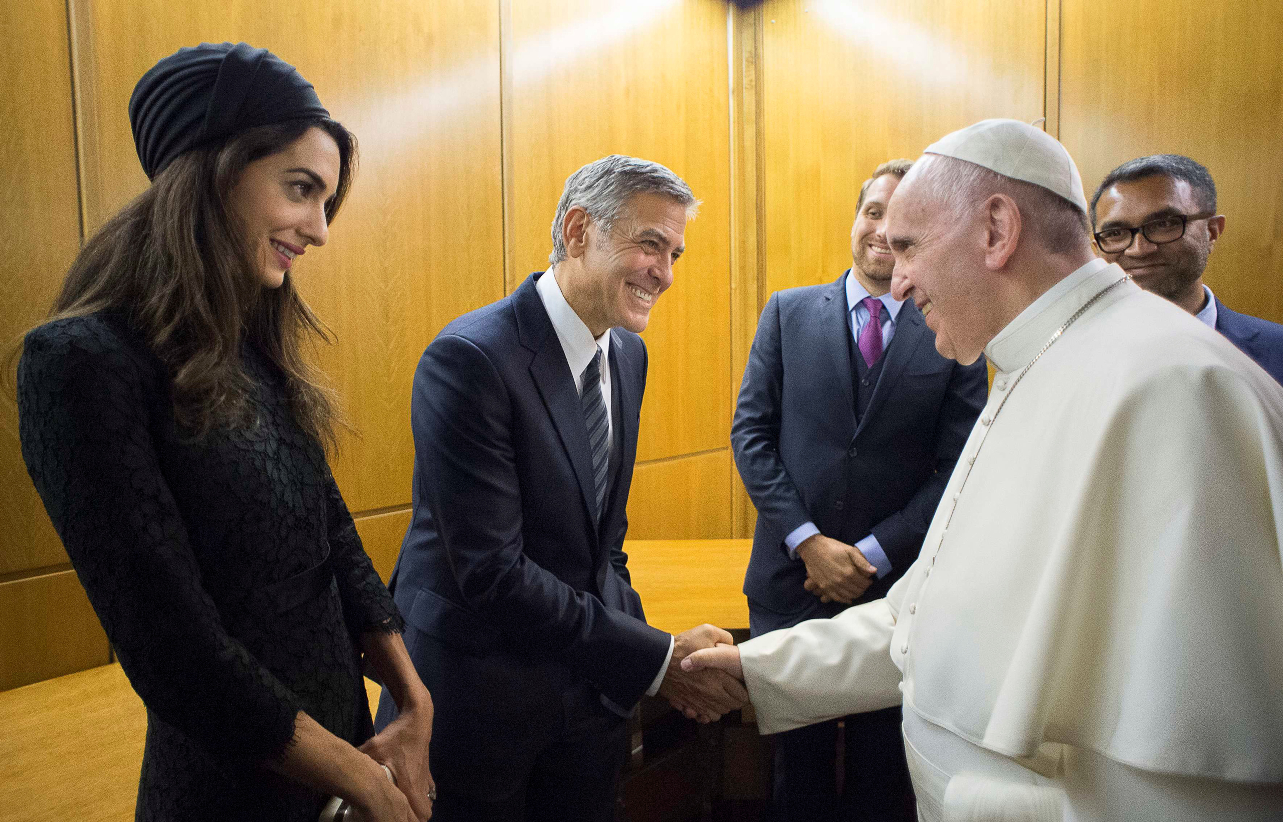 Pope Francis meets George and Amal Clooney during a meeting of the Scholas Occurrentes at the Vatican on May 29, 2016. (Osservatore Romano/Reuters)