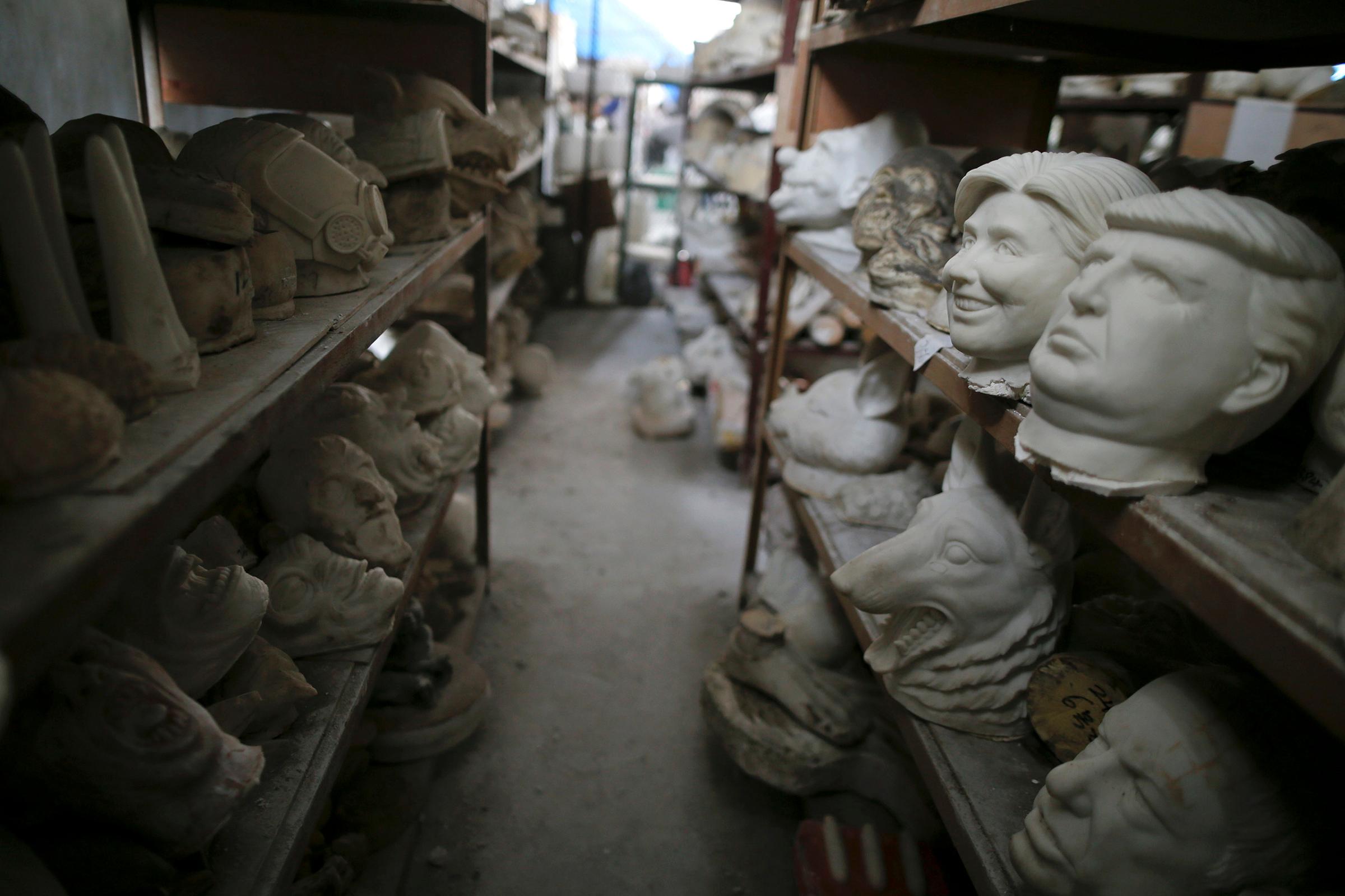 Molds for different masks, including those of Democratic presidential candidate Hillary Clinton and Republican presidential candidate Donald Trump, sit on shelves at Jinhua Partytime Latex Art and Crafts Factory in Jinhua, Zhejiang Province, China, May 25, 2016.