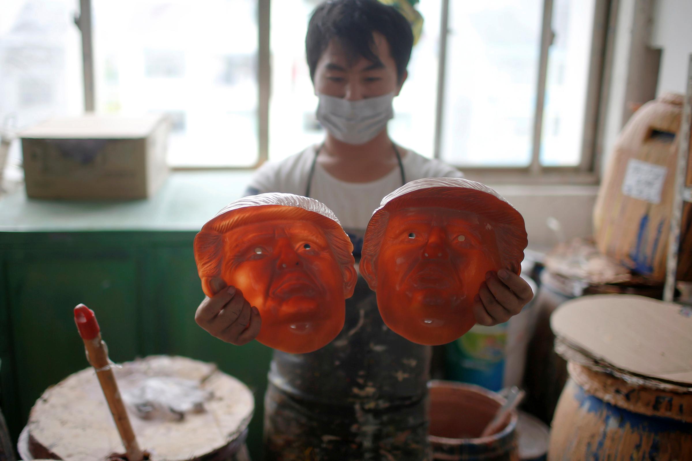 A worker checks masks of Republican presidential candidate Donald Trump at Jinhua Partytime Latex Art and Crafts Factory in Jinhua, Zhejiang Province, China, May 25, 2016.