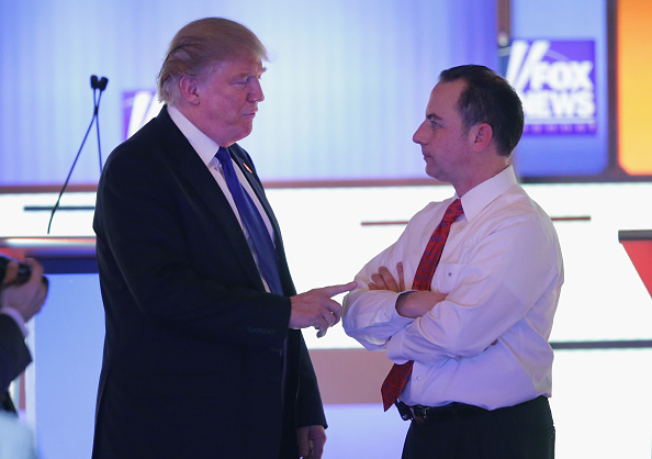 Republican presidential candidate Donald Trump (L) speaks with Reince Priebus, chairman of the Republican National Committee, at a debate sponsored by Fox News at the Fox Theatre on March 3, 2016 in Detroit, Michigan.