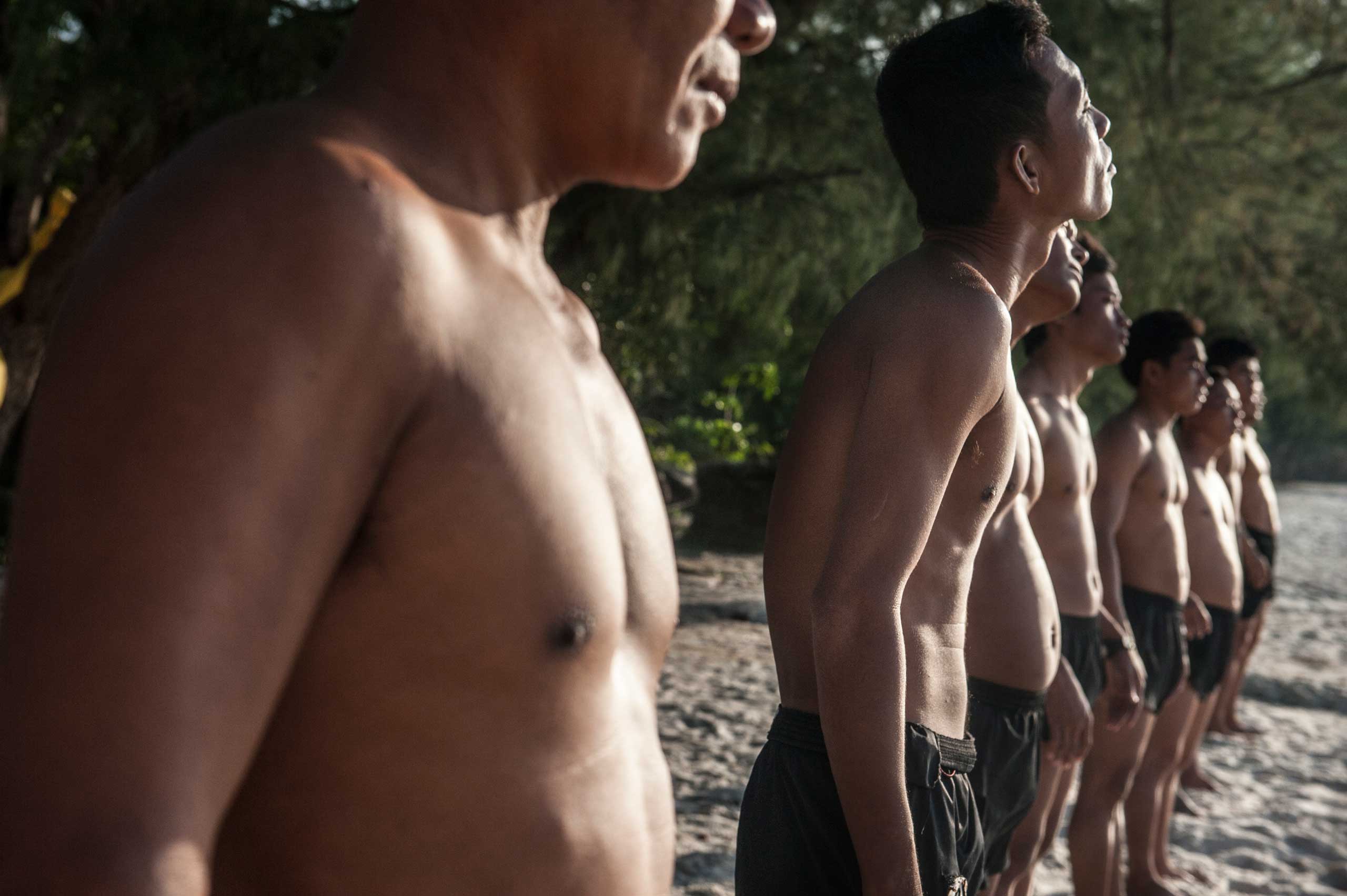 The UXO salvage diver team lines up ahead of a sea swim for training on the island of Koh Rong off the coast of Sihanoukville, Cambodia in April 2013. The divers were previously de-miners with the Cambodian Mine Action Centre and were selected by the Golden West Humanitarian Foundation from a group of over 40 applicants.