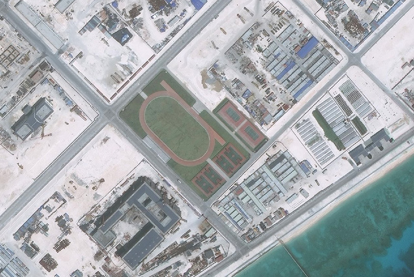 A satellite image of Fiery Cross Reef captured on May 1, 2016, shows a running track, four basketball courts and two tennis courts.