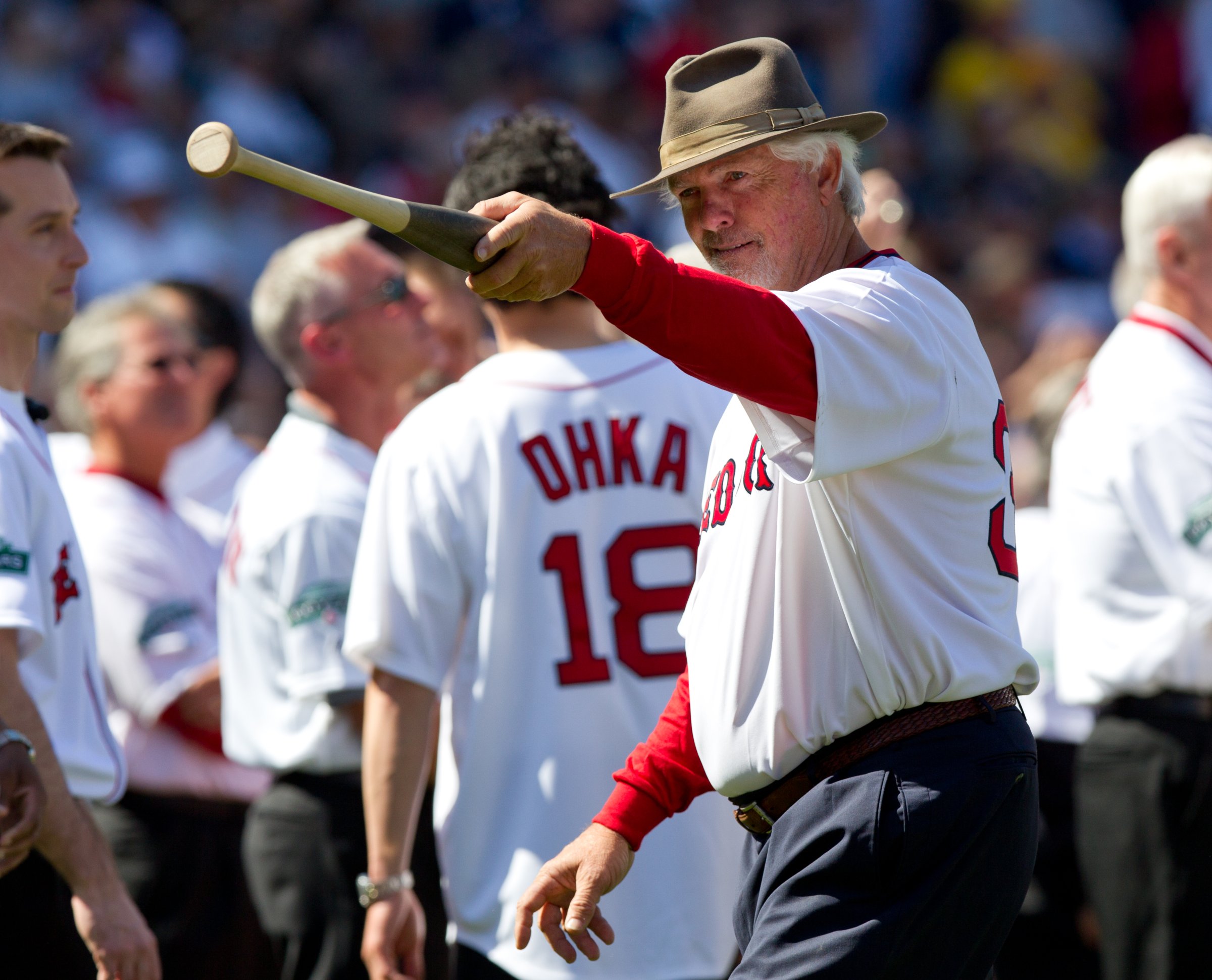 Former Boston Red Sox pitcher Bill "Spaceman" Lee points to the dugout during ceremonies before the game between the Boston Red Sox and the New York Yankees in Boston, April 20, 2012.