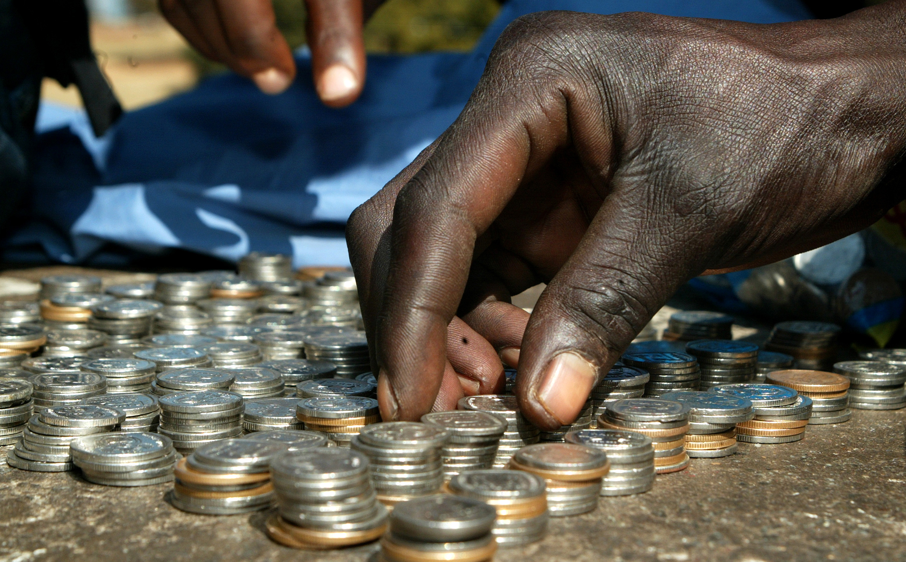 A coin vendor counts his coins on June 2