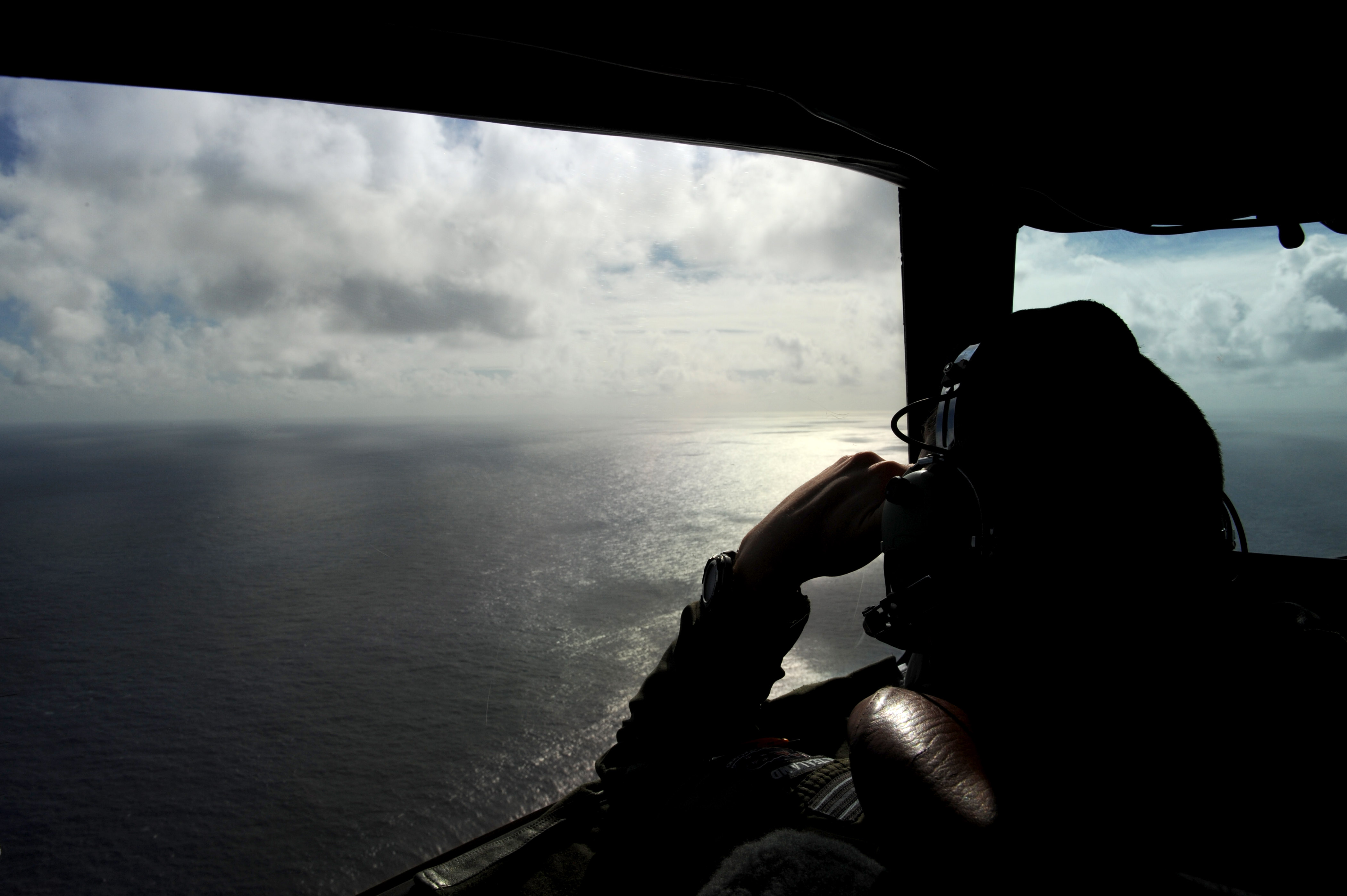 Flight Lieutenant Timothy McAlevey of the Royal New Zealand Airforce helps look for objects during the search for missing Malaysia Airlines Flight MH 370 off the coast of Perth, Australia on April 13, 2014. (Pool—Getty Images)