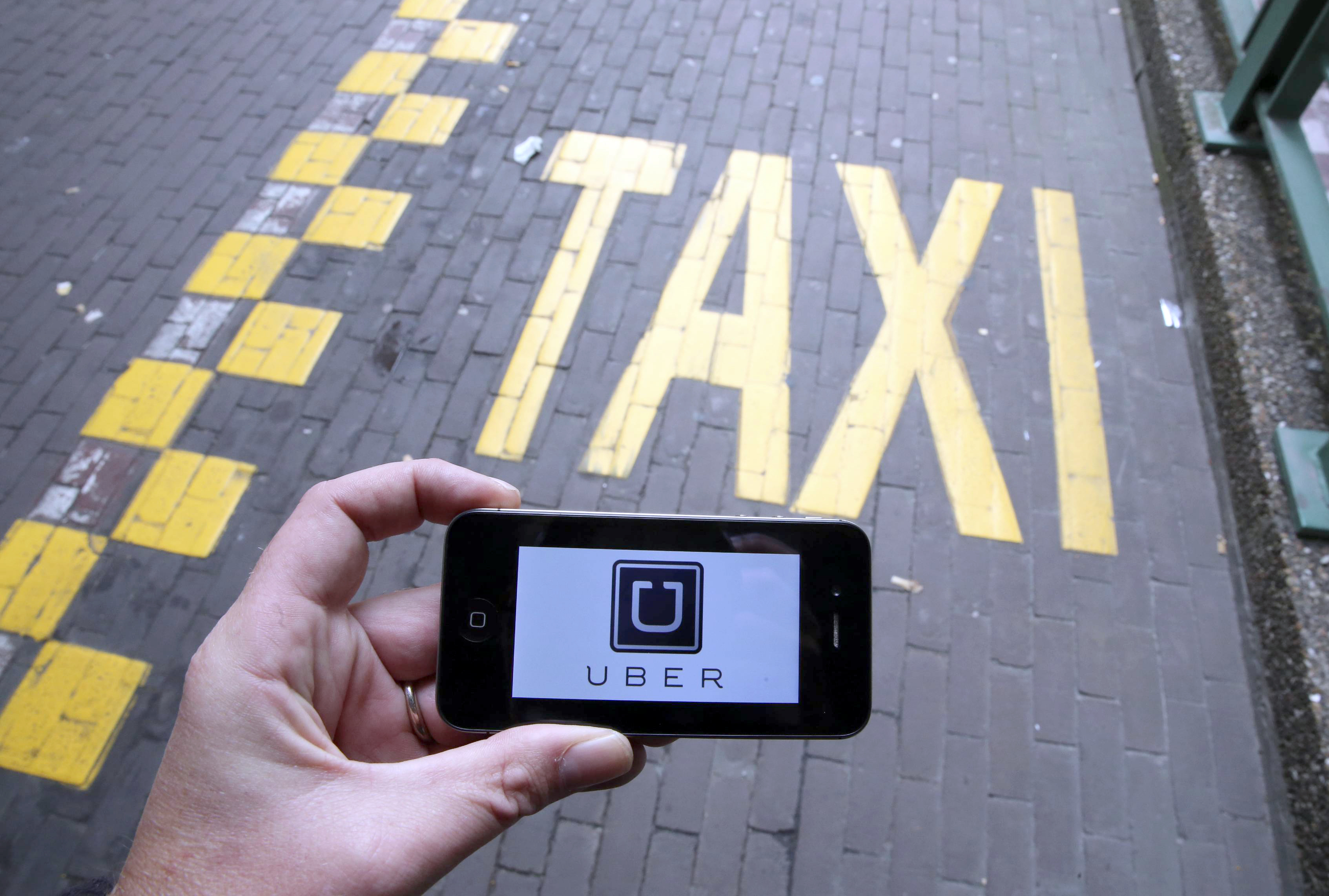 Majority of users don't think Uber should be regulated like a taxi. (Nicolas Maeterlinck—AFP/Getty Images)