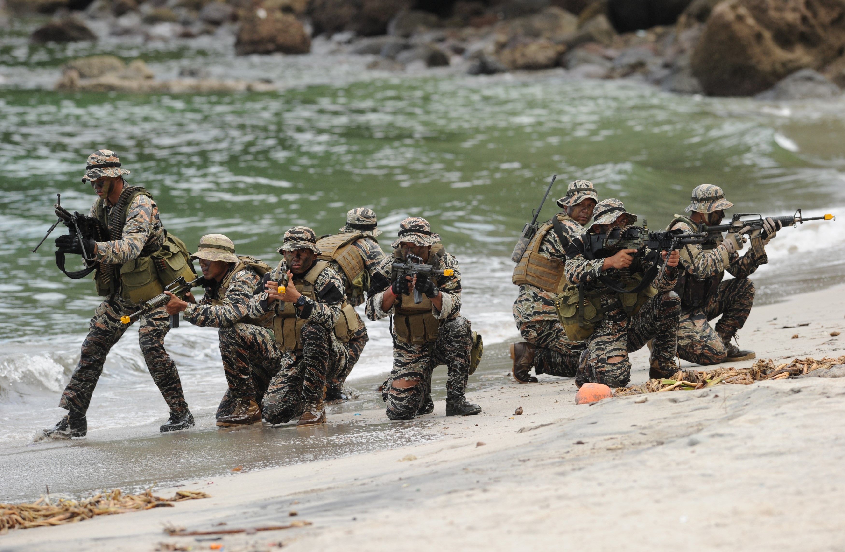 Members of the Philippine Navy Special Operations Group (NAVSOG) take their positions as they simulate the rescue of a hostage victim as part of an amphibious raid and special operations exercise by the navy at a marine training base in the town of Ternate in Cavite province, the Philippines, on Sept. 24, 2015, days after gunmen abducted three foreigners and one Filipina from a luxury island resort on Samal island (Ted Alijibe—AFP/Getty Images)