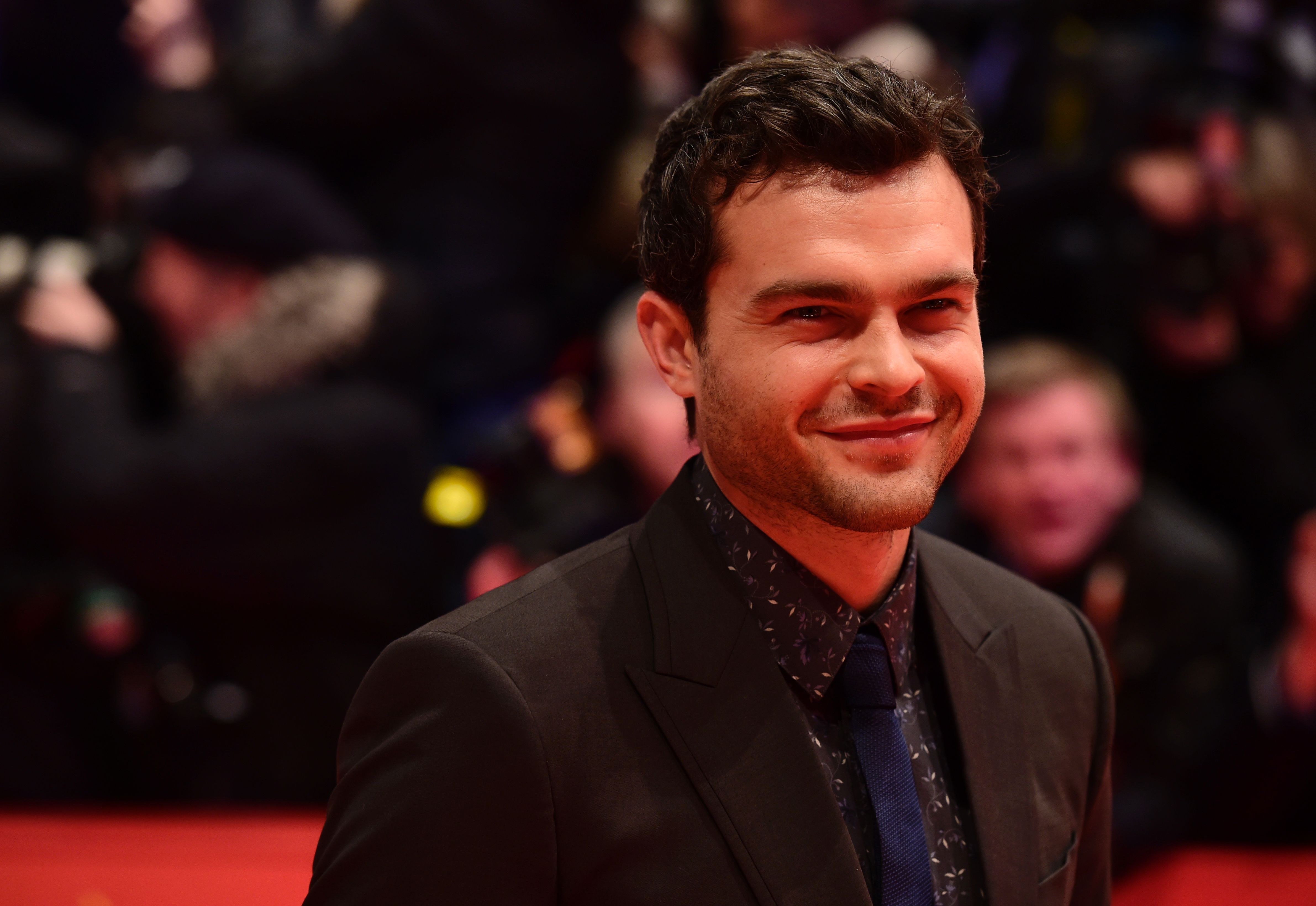 Alden Ehrenreich poses for photographers as he arrives on the red carpet for the film "Hail, Caesar!" screening in Berlin, Feb.11, 2016 (John MacDougall—AFP/Getty Images)