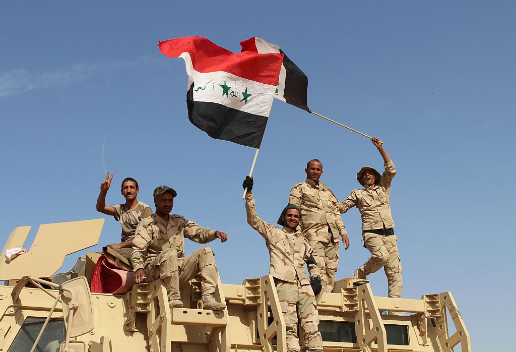 Iraqi government forces wave their national flags on March 10, 2016 after retaking the town of Zankura, northwest of Ramadi, from the Islamic State (IS) jihadist group in Anbar province. 
                      Iraqi forces retook a town from the Islamic State jihadist group in Anbar province Thursday and evacuated 10,000 civilians as they advanced up the Euphrates valley, a security spokesman said. The sprawling province of Anbar -- which borders  Syria, Jordan and Saudi Arabia -- was at the heart of the "caliphate" that IS proclaimed in 2014. The jihadist group still holds most of the province but the noose is tightening around some of its key bastions.
                      
                       / AFP / MOADH AL-DULAIMI        (Photo credit should read MOADH AL-DULAIMI/AFP/Getty Images) (MOADH AL-DULAIMI&mdash;AFP/Getty Images)