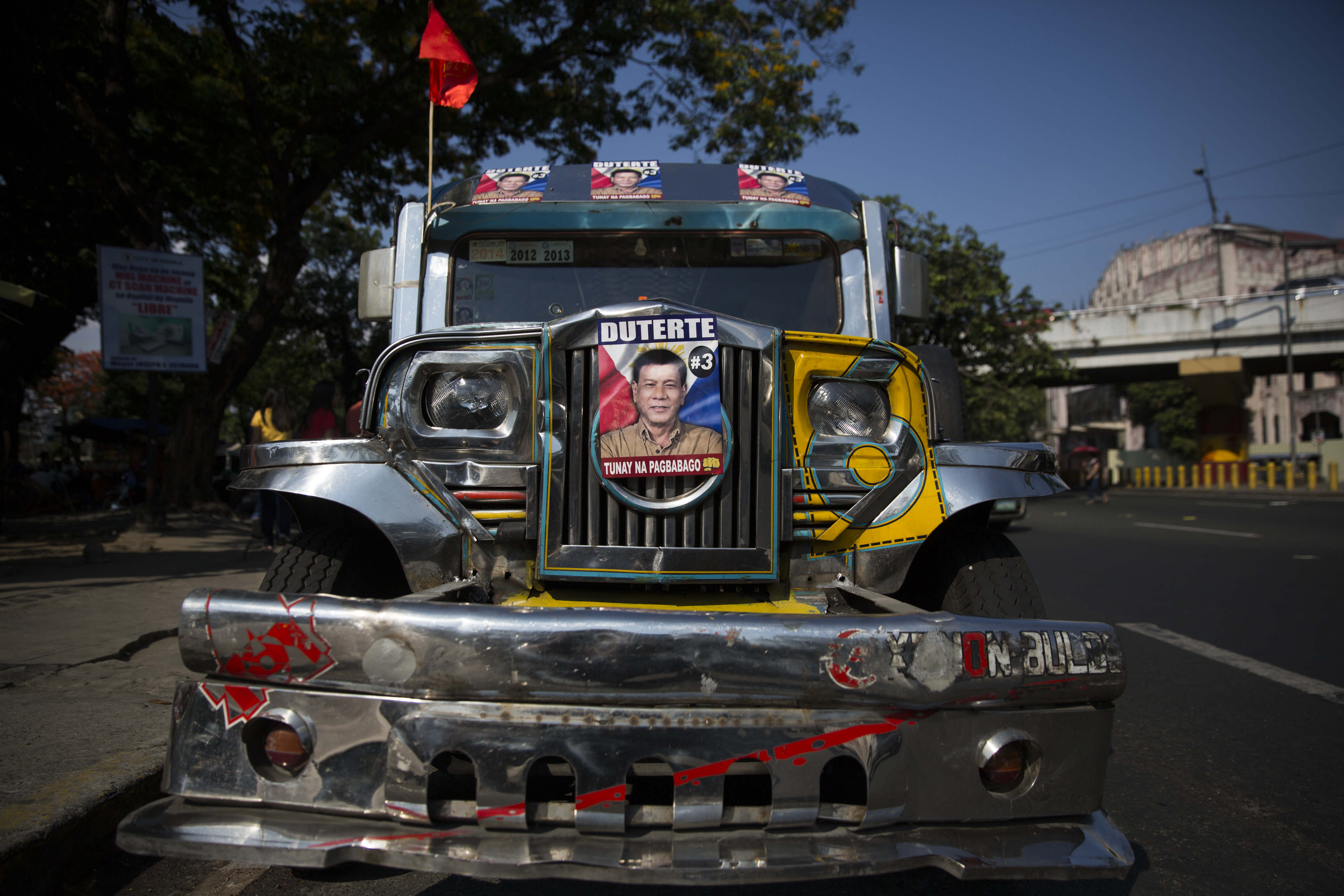 A jeepney, or jeep, is decorated with posters showing the face of Rodrigo Duterte, mayor of Davao City and presidential candidate, at a campaign rally in Manila on May 1, 2016 (Taylor Weidman—Bloomberg/Getty Images)