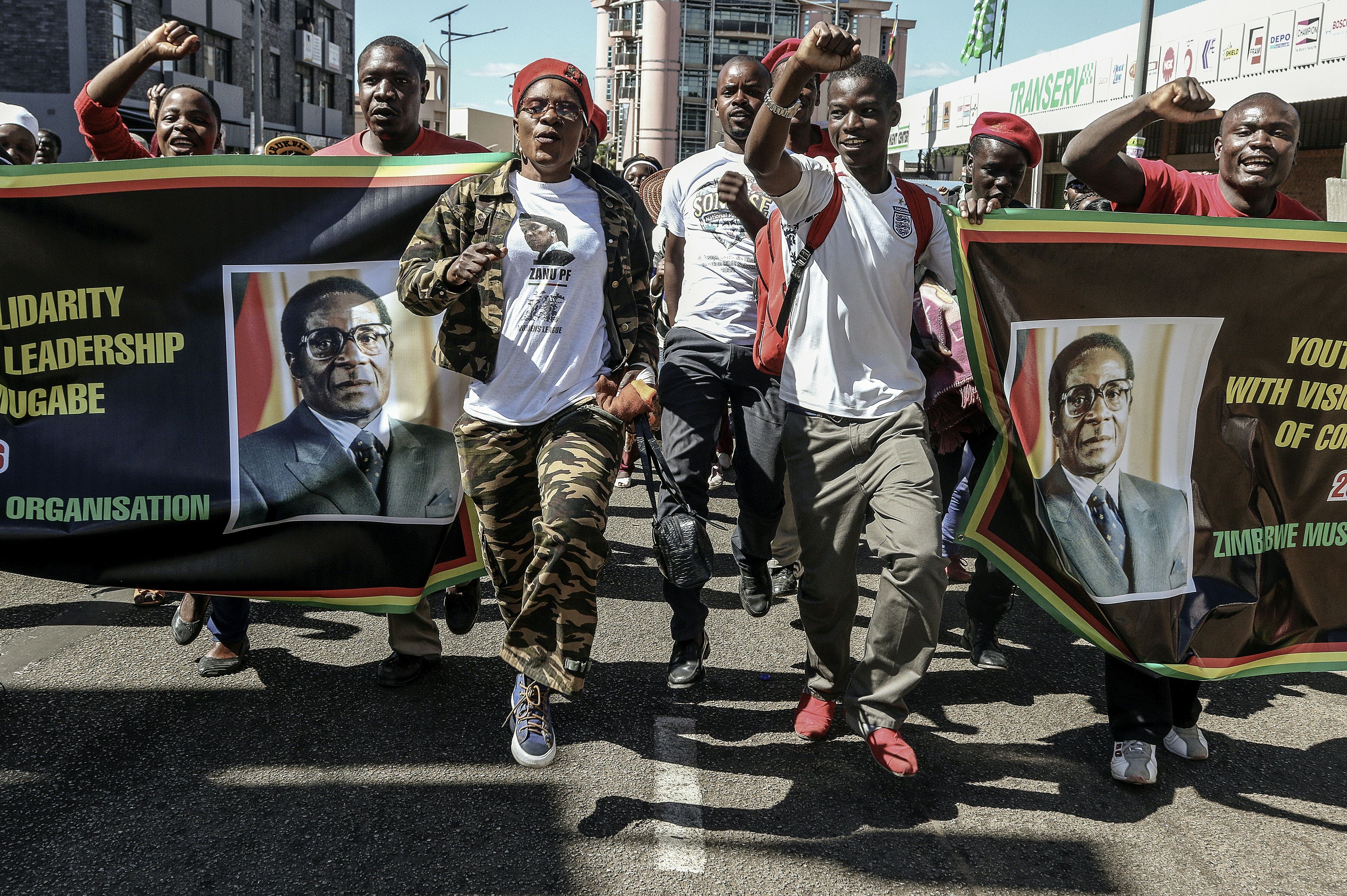 Youth Supporters of Zimbabwean President cheer during the Zimbabwe African National Union Patriotic Front "One Million Youth March" on May 25, 2016 in Harare (Jekesai Njikizana—AFP/Getty Images)